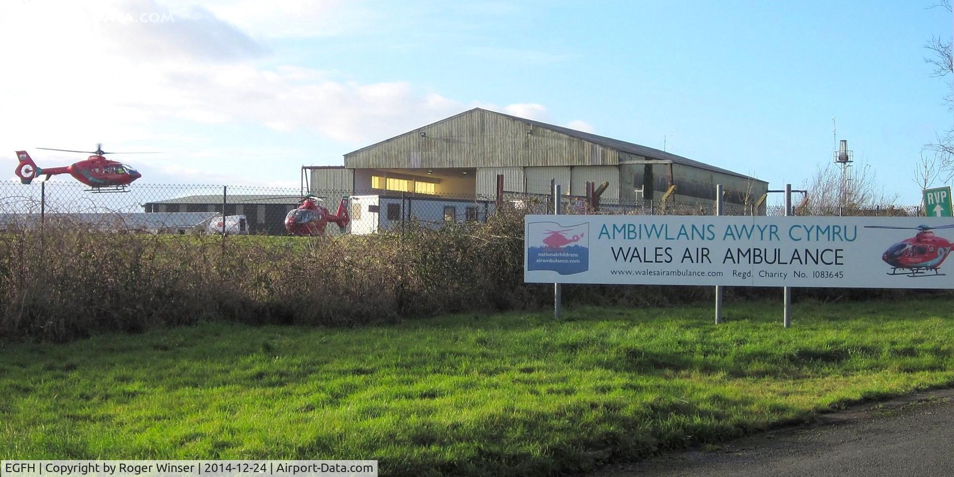 Swansea Airport, Swansea, Wales United Kingdom (EGFH) - Visiting mid-Wales based Air Ambulance helicopter departing the South Wales air ambulance base at Hangar 1 for Welshpool Airport.