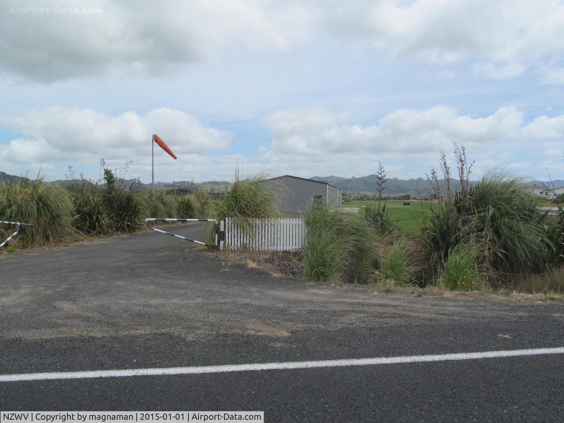 Waihi Beach Aerodrome Airport, Waihi Beach New Zealand (NZWV) - No signs of activity with the one hangar shut even though it is mid summer! Strip is right behind the beach. Photo taken out of wndow whilst driving along the road!!