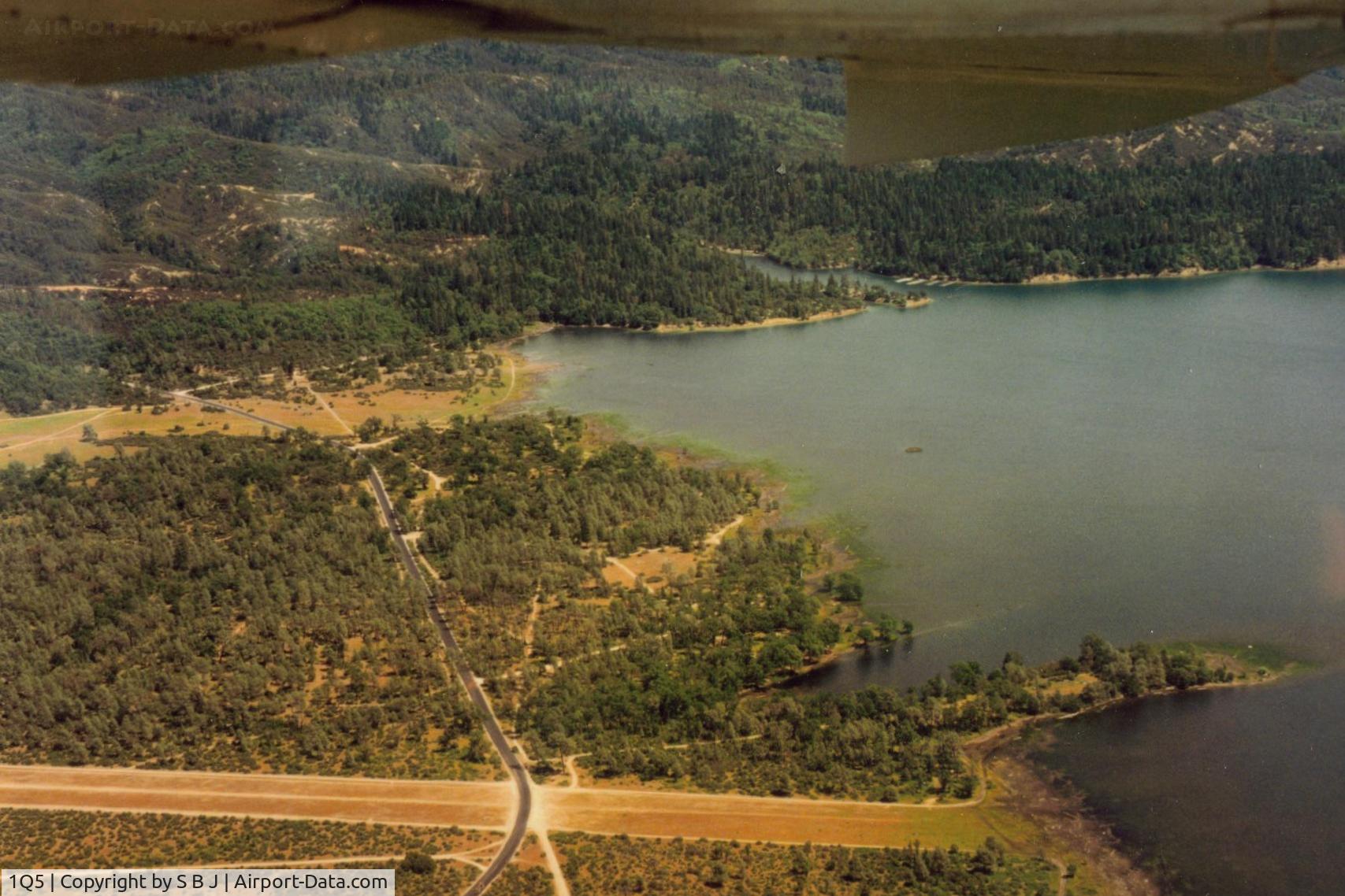 Gravelly Valley Airport (1Q5) - This picture shows the road that crosses the south end of runway.While there are stop signs,vehicles do not always stop.Landing, a pilot should be prepared for this!!Seen more then one pilot startled when a car appeared when landing.