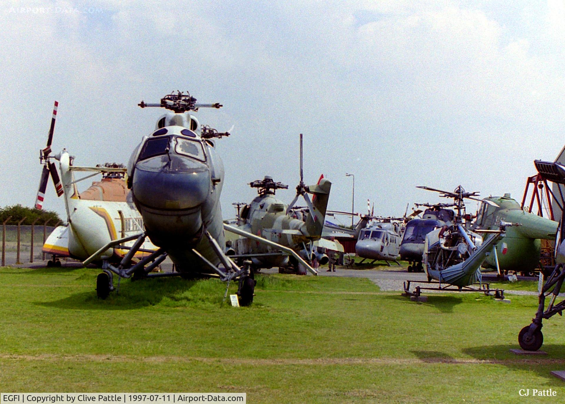 EGFI Airport - Wide picture of the external storage area at the International Helicopter Museum, Weston Super Mare, Somerset, England as it was  in 1997. A lot of these aircraft have now been restored and housed inside the museum.