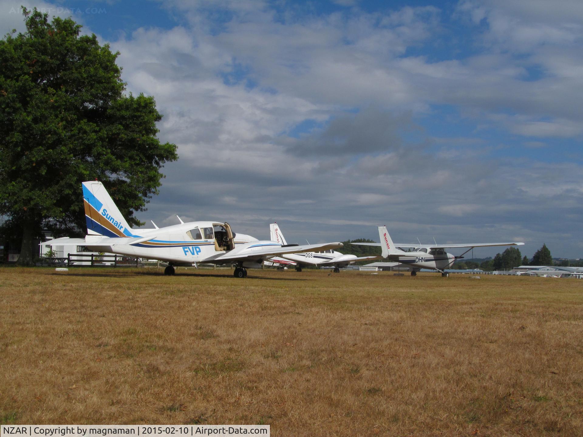 Ardmore Airport, Auckland New Zealand (NZAR) - view of grass parking area next to café.
Three sunair planes - visiting or possibly for sale?