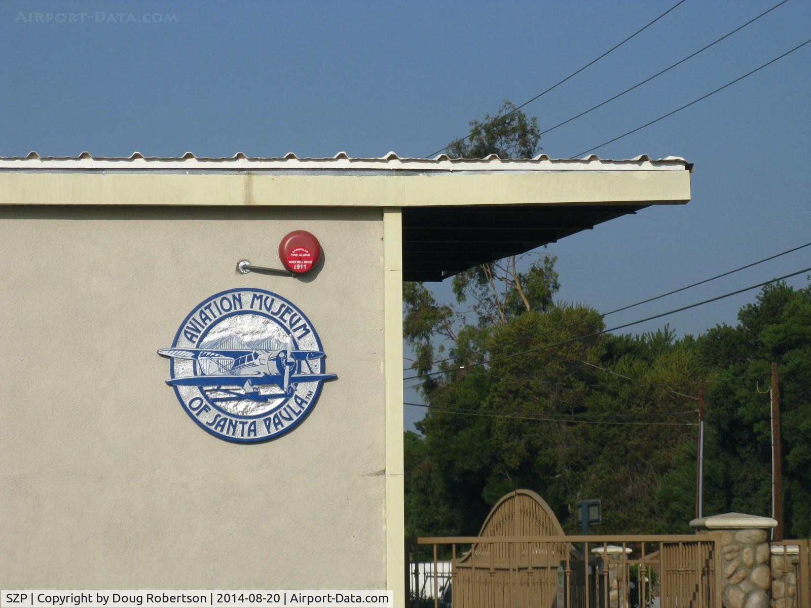 Santa Paula Airport (SZP) - Aviation Museum of Santa Paula Logo on main museum hangar invokes the spirit of 1930s aviation when airport was founded (1930). Artist-Wendell Dowling