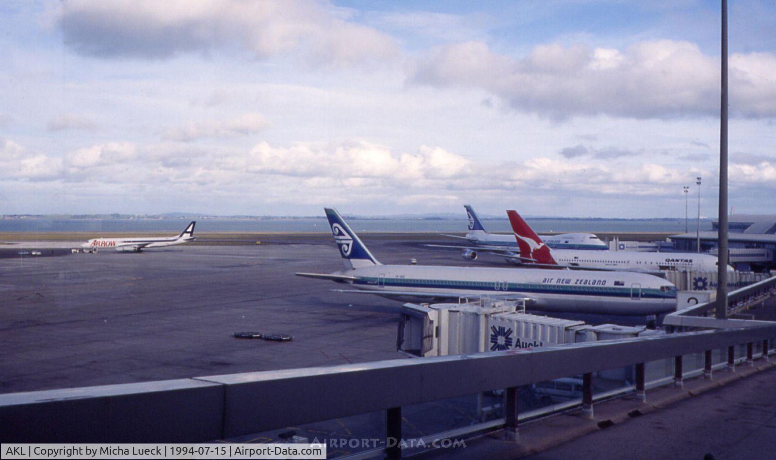 Auckland International Airport, Auckland New Zealand (AKL) - Nice shot of the apron at Auckland: Arrow's good old DC8, a B767-300 and a B747-200 in Air NZ's old livery, and a Qantas B767-200