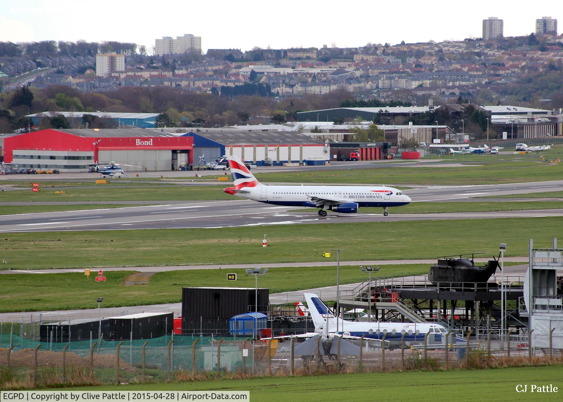 Aberdeen Airport, Aberdeen, Scotland United Kingdom (EGPD) - A newly arrived BA A320 taxies from the runway at Aberdeen EGPD. Note the fire training area (with ex RN Jetstream T.2 and ex RAF Jaguar GR.3) in the foreground and the parked Bond Helicopters and GA park in the background