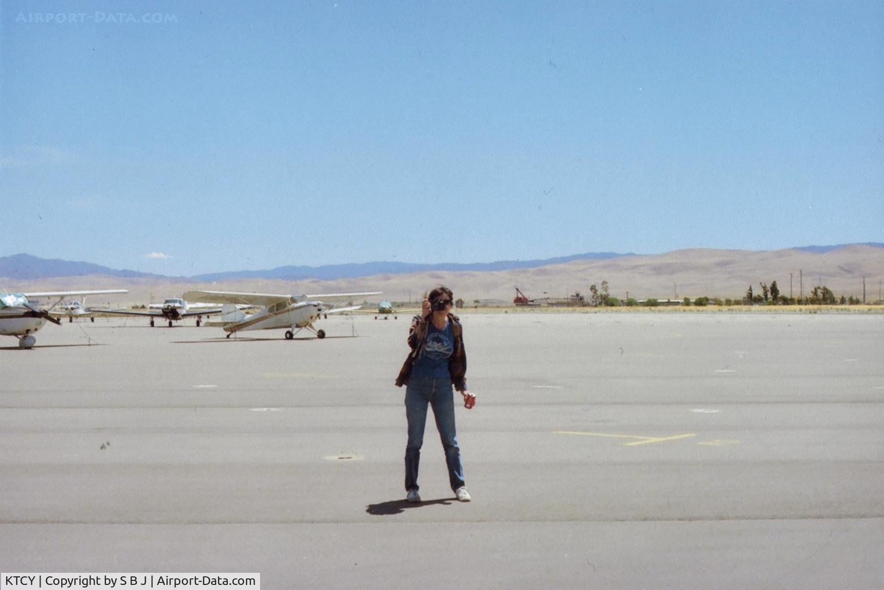 Tracy Municipal Airport (TCY) - N4385E (the Aeronca Chief seen in distance) owner taking pictures at picturesque Tracy airport. Not sure many others did-picture taking that is. View is to the south and runway 30.