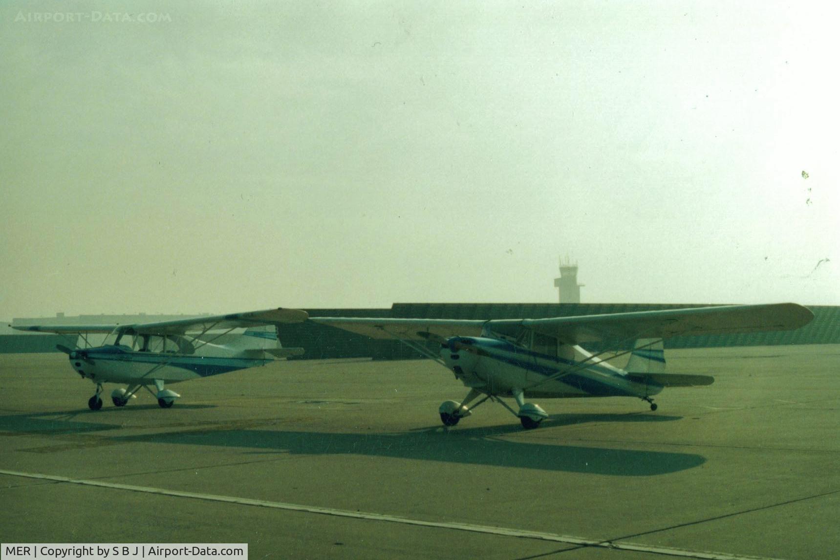 Castle Airport (MER) - I believe those are blast shields behind the planes.In the 70s it was not unusual to see 3or4  B52s flying around  at a time.They were easy to spot,just looked for the trails of  dark smoke and I always gave them a wide berth.What a (impressive) sight!