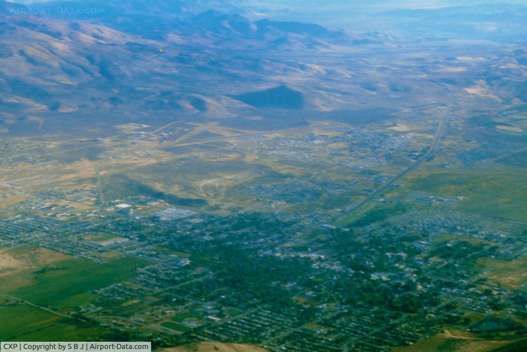 Carson Airport (CXP) - Carson City is seen near mts.Dirt crosswind runway(seen best) was welcome on one arrival with gusty 35kt winds with 5-10 seconds of dead calm mixed in .Nasty stuff but the dirt runway was perfectly aligned for my Tcraft.View is north.