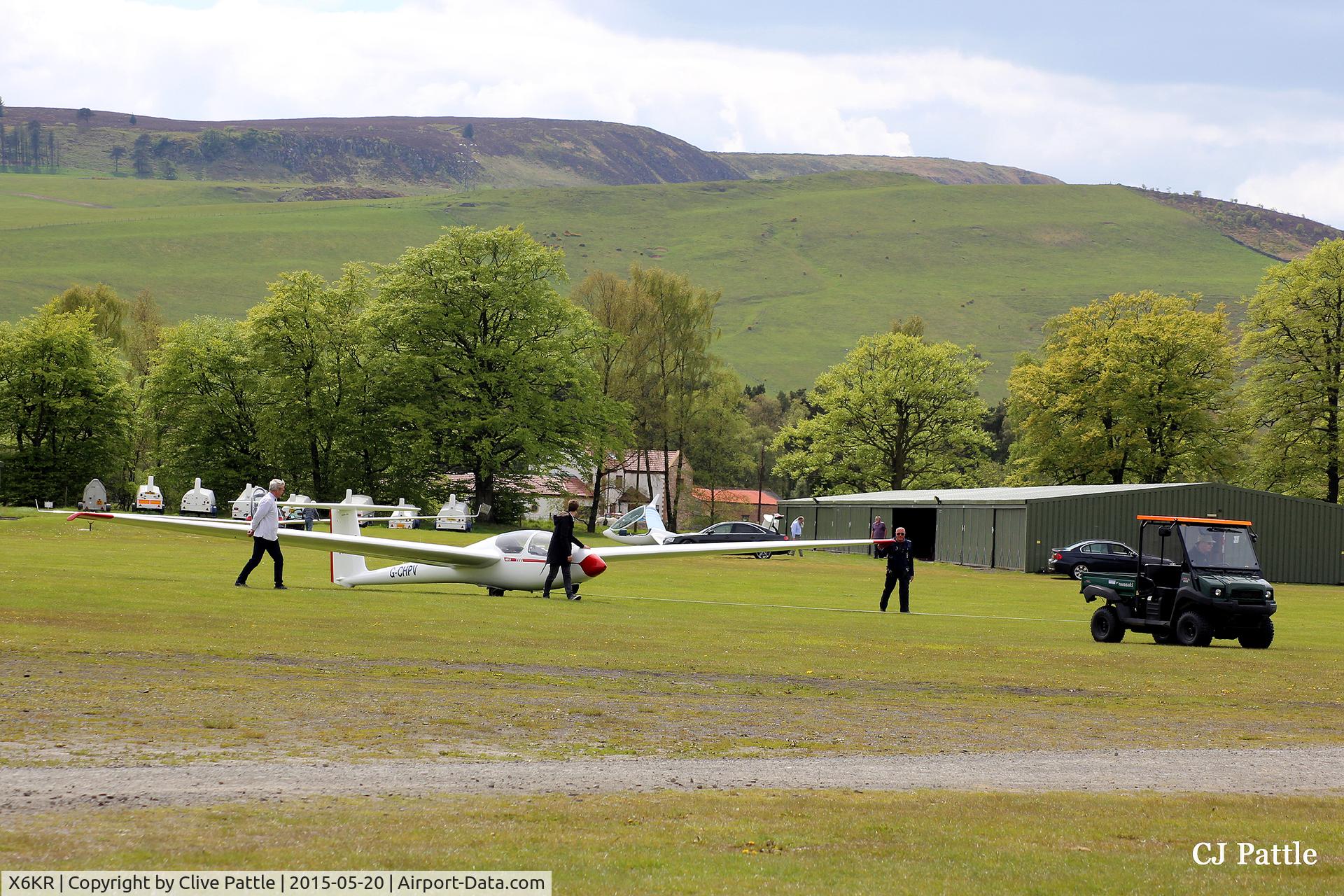 X6KR Airport - Willing hands haul a recently landed glider back to the winch to re-launch