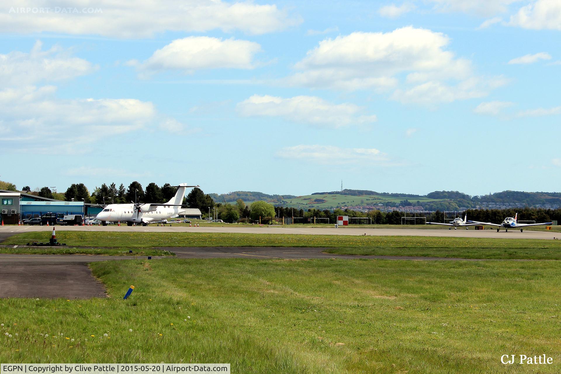 Dundee Airport, Dundee, Scotland United Kingdom (EGPN) - A quiet regional airport, Dundee Riverside EGPN. An unmarked  Dornier 328 G-BZOG of Flybe/Loganair on the ramp ready for its return flight to London Stansted EGSS. A couple of Tayside Aviation trainers carry out pre-flight engine checks.