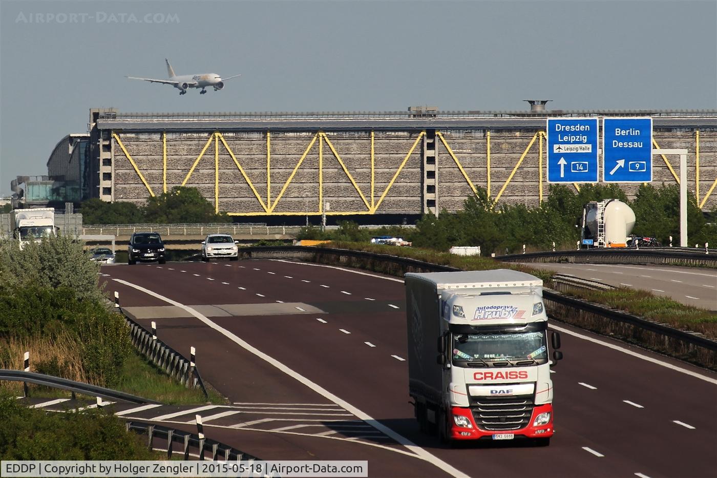 Leipzig/Halle Airport, Leipzig/Halle Germany (EDDP) - Inbound traffic on rwy 26L on final. In front airport parking garage at Autobahn 14. From windows on the left you can take pretty pics of aircrafts passing rolling bridge from and to rwy 08L/26R....