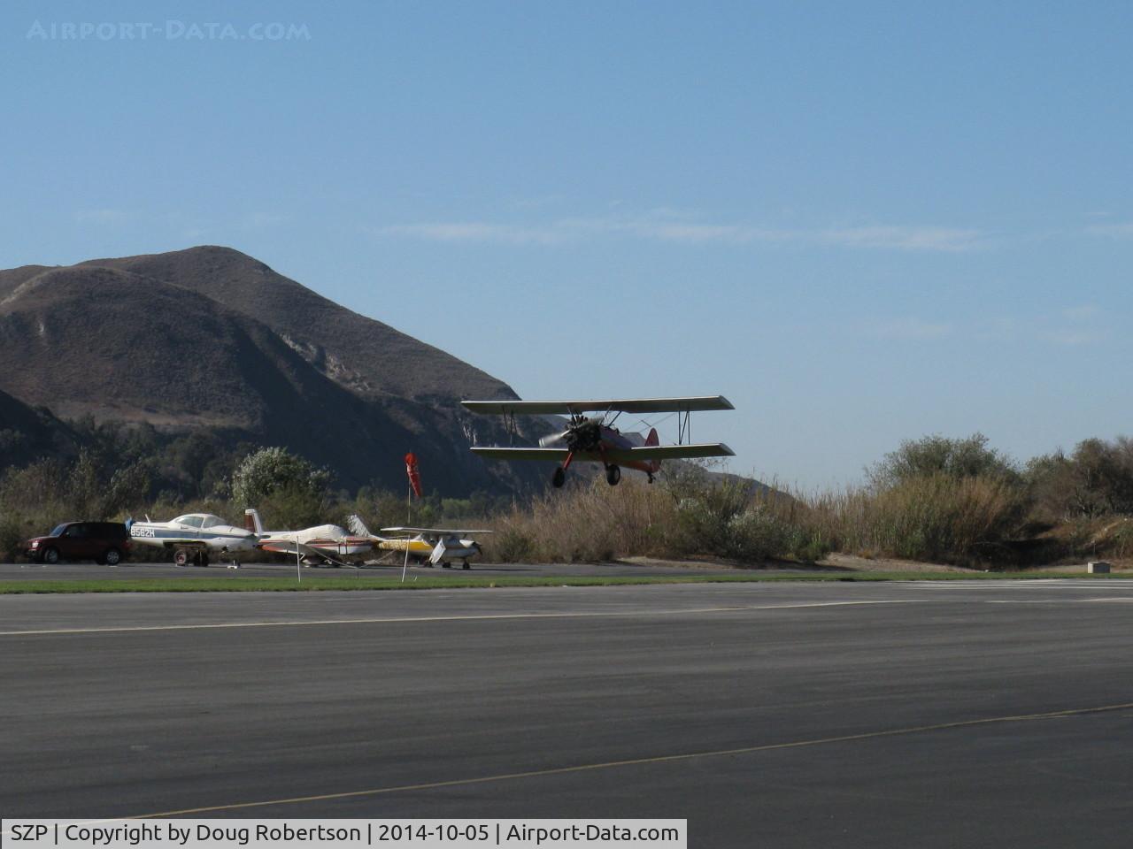 Santa Paula Airport (SZP) - N65124 Boeing Stearman with upgraded P&W R985 Wasp Jr. by Jacobs-450 Hp, making high speed low pass at 22L banner tow array for successful advertising banner tow pickup. Please watch complete sequence here.