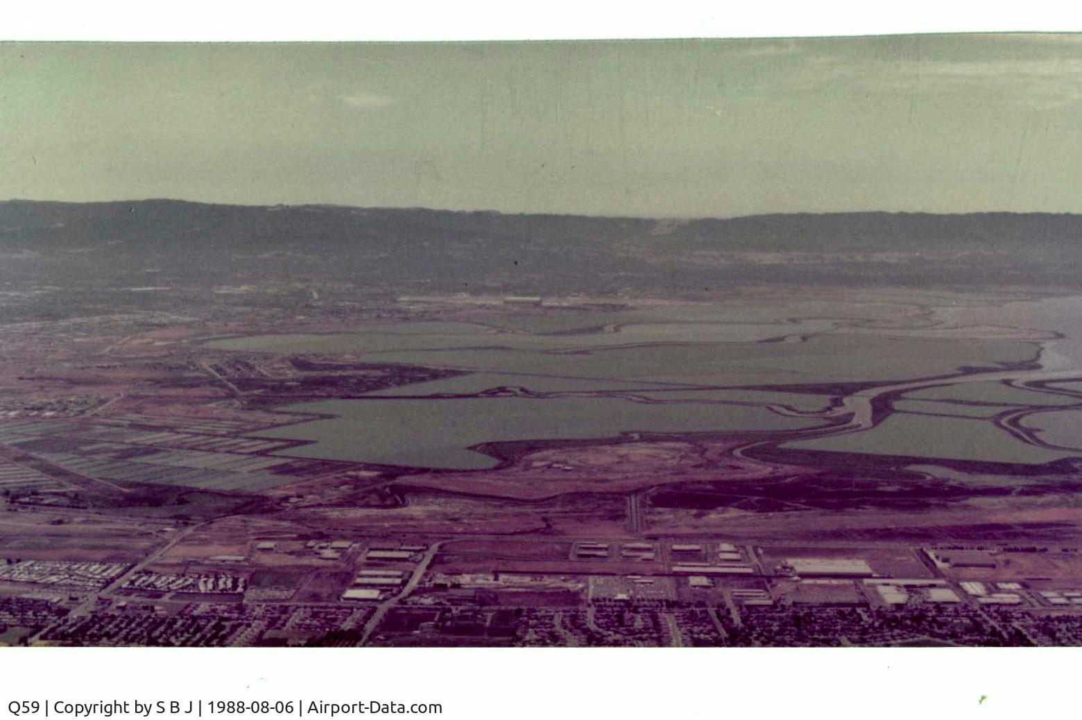 Q59 Airport - Fremont airport is at the bottom of picture and Moffett Federal airport (NUQ) is above it seen in the distance. View is to the west.Picture is from 1986 soon after closure.Years of following the levees(at safe alt) sure helped flying coordination.
