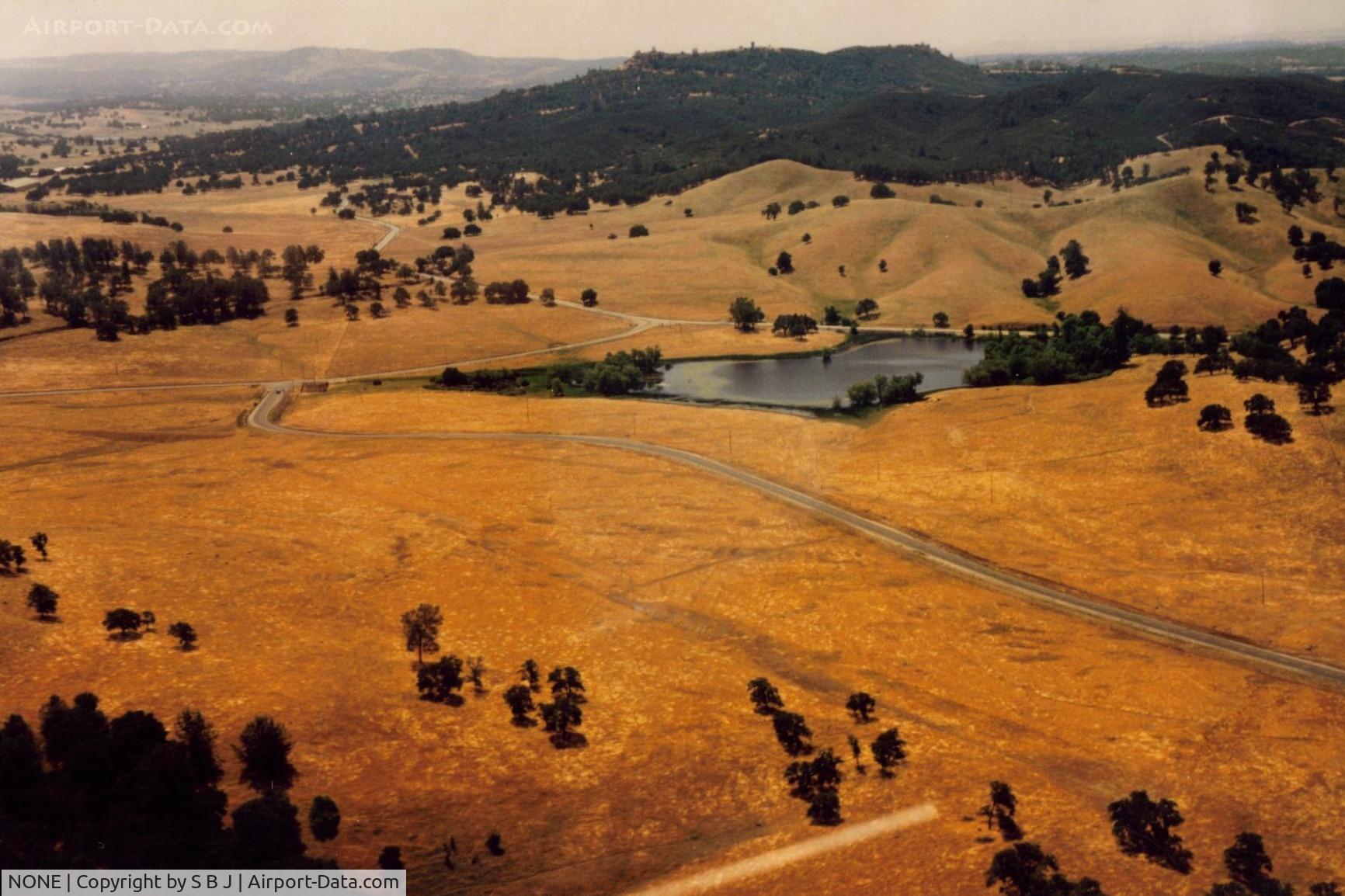 NONE Airport - Pardee Dam strip.My dad landed here in 1961 on a fishing trip in the near by reservior.A wheel pant came off on landing due to improper installation-by me.Dam is 10 miles from Jackson,Ca.and is not in picture.That is only a small pond. View is north.