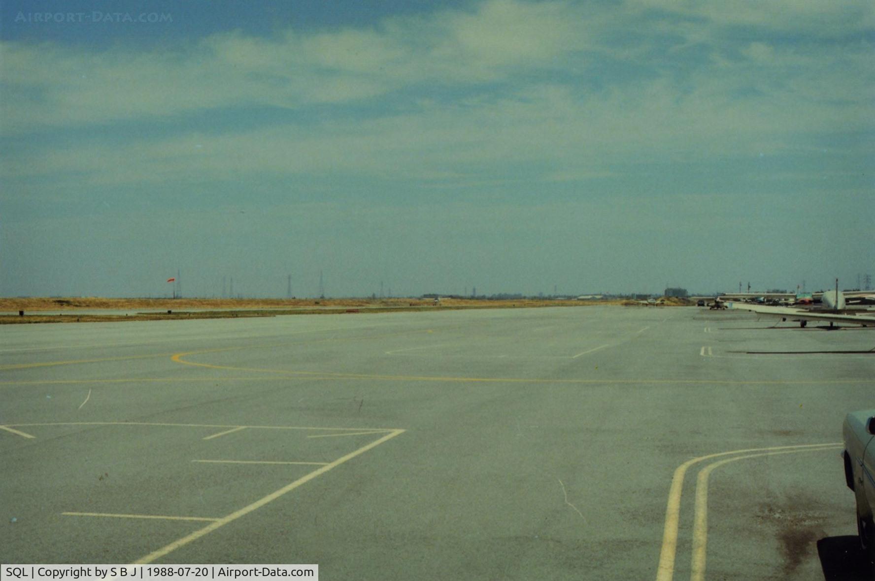 San Carlos Airport (SQL) - View one would have taxiing out from the west side to runway 30. Did this for several years in the 80s. View is to the south. Other then the summertime crosswinds,San Carlos was a nice airport and in the mid 80s had some good tower people.