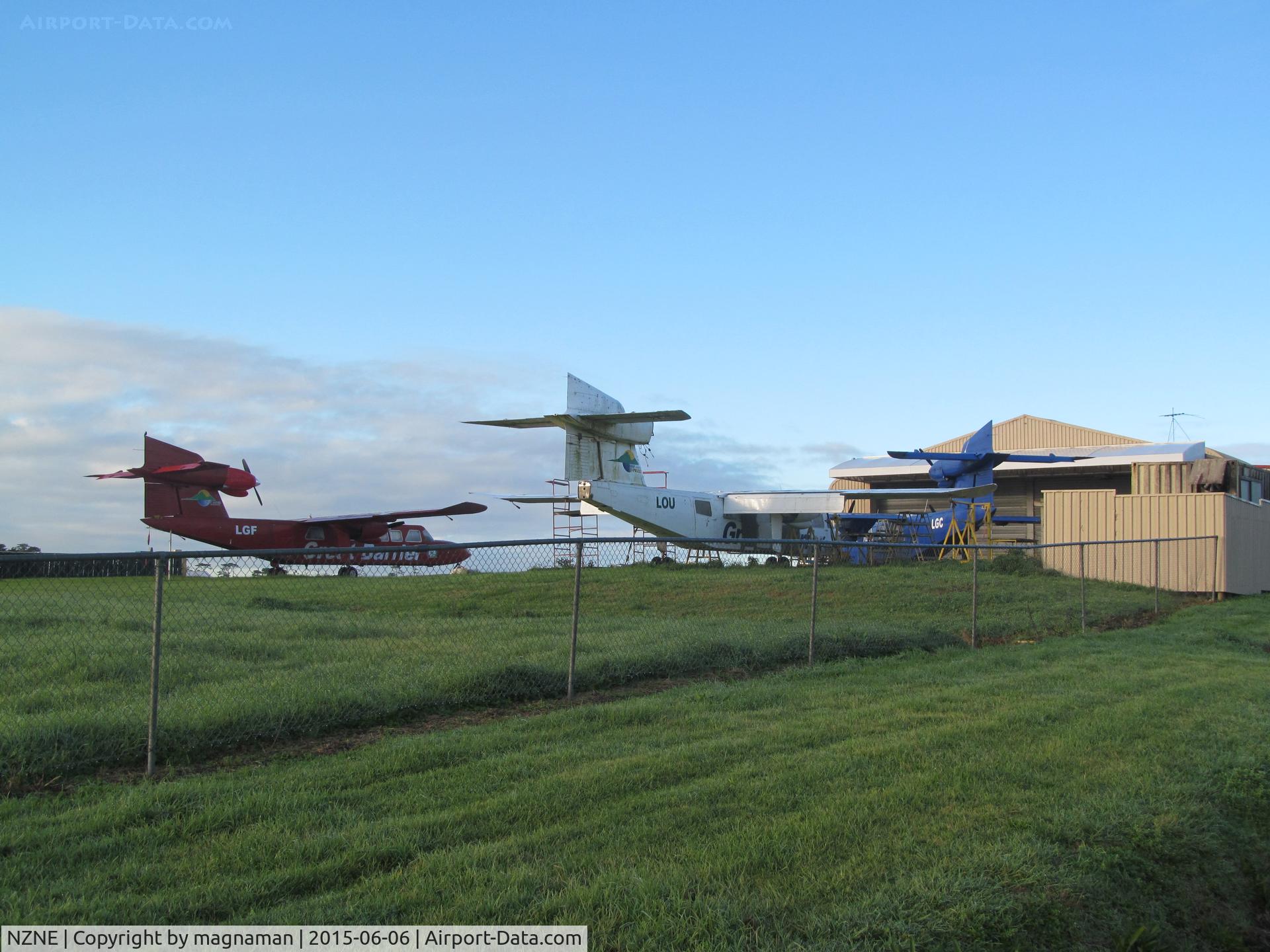 North Shore Aerodrome Airport, Auckland New Zealand (NZNE) - Trislander graveyard. ZK-LOU / LGC / LGF plus VH-NXW between old hangars and another unidentified white one.