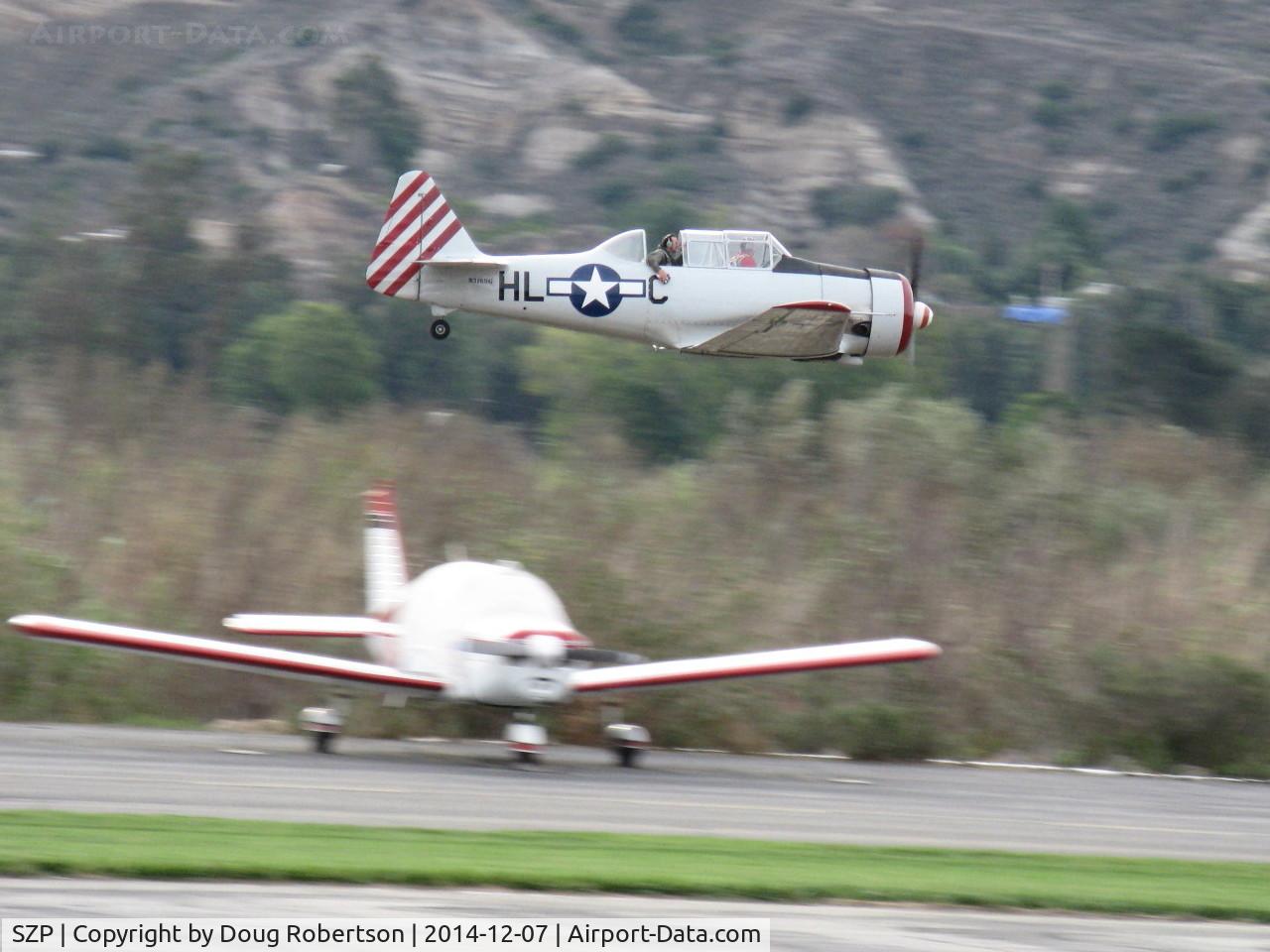 Santa Paula Airport (SZP) - Condor Squadron making another high speed flour bomb pass at riverbed target, Commemorating 7 Dec. 1941 attack on Pearl Harbor. Official scorers were near Rwy 04 windsock cordoned off area.