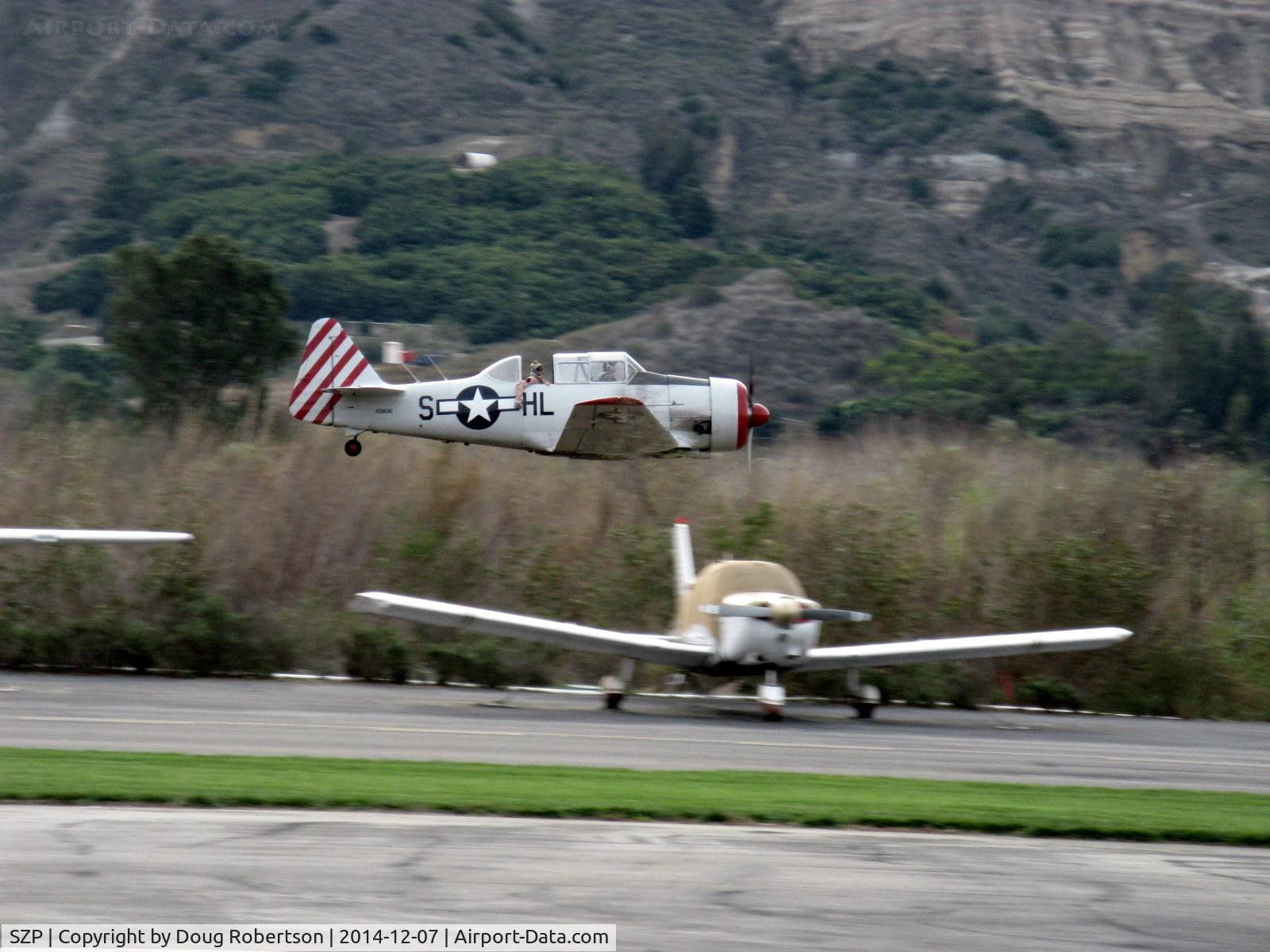 Santa Paula Airport (SZP) - Condor Squadron making another high speed flour bombing pass at riverbed target Commemorating 7 Dec. 1941 attack on Pearl Harbor which started WWII for America.
