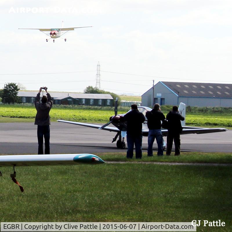 EGBR Airport - Spotters doing what they do best at Breighton EGBR during the 'Radial Fly-in' - I don't know what difference holding your camera up in the air above your head makes !