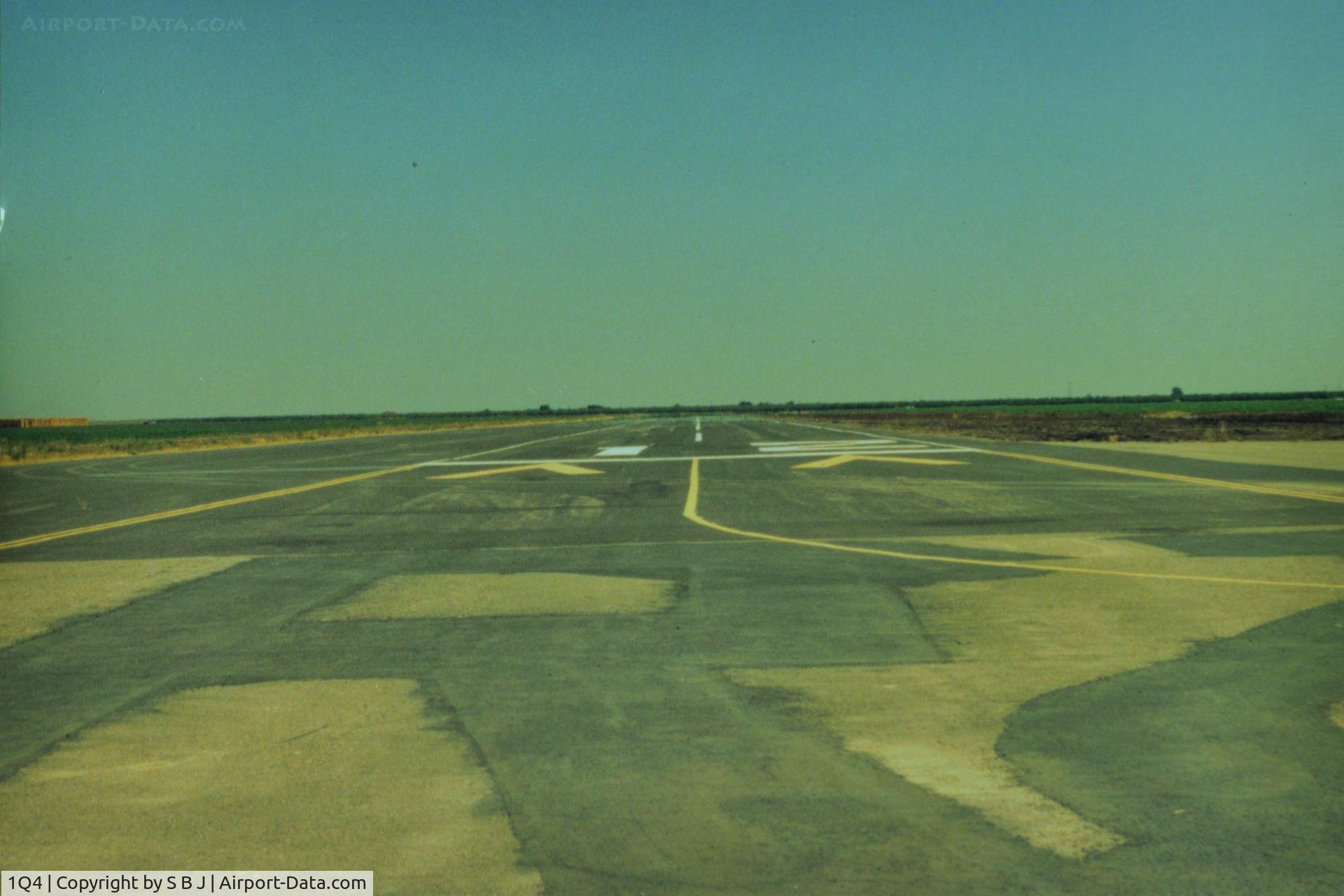 New Jerusalem Airport (1Q4) - View down runway 12.At one point the FAA said the threshold was to near an existing irrigation ditch, so airport was closed.Somebody came up with the idea of moving threshold  down 300 feet as seen. FAA happy and airport reopened.