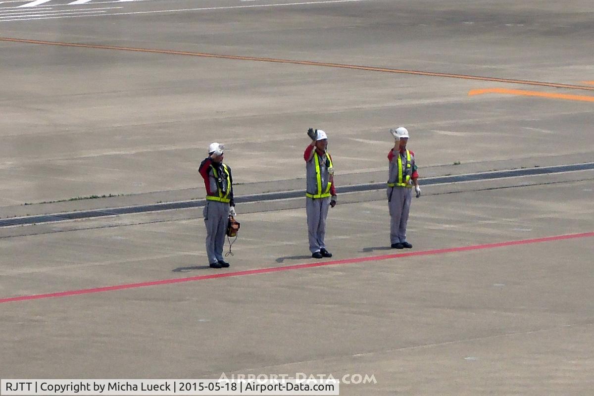 Tokyo International Airport (Haneda), Ota, Tokyo Japan (RJTT) - I love that friendly gesture of ground staff waving flights good-bye. I have only ever seen it in Japan and in Hawai'i