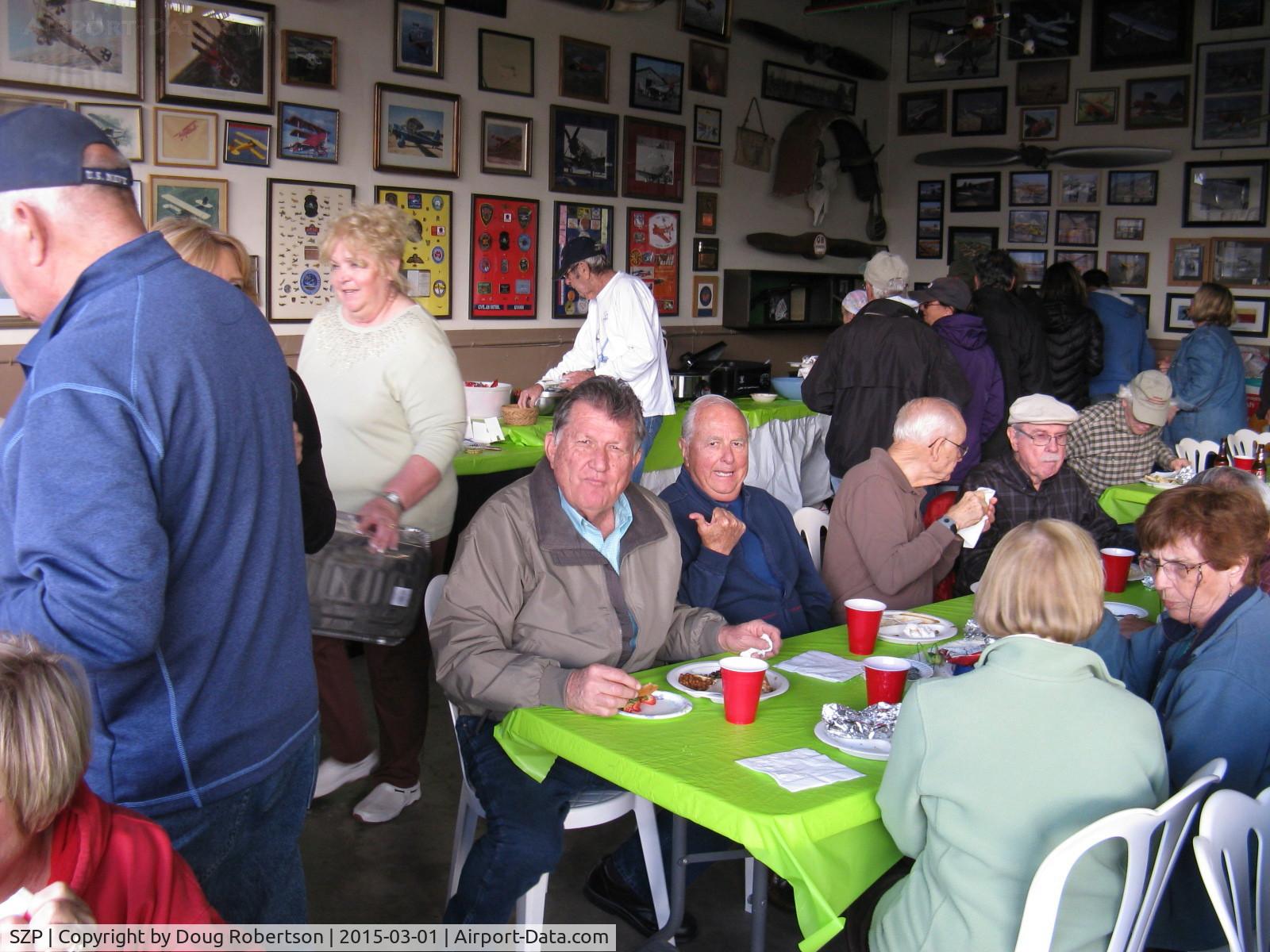 Santa Paula Airport (SZP) - Pat Quinn Bucker Museum Hangar with host Pat and Arlys standing behind, at his great barbecue luncheon with many friends gathered for his FAA Award ceremony-Wright Bros. Master Pilot Award for 50 years accident free-no violations flying.