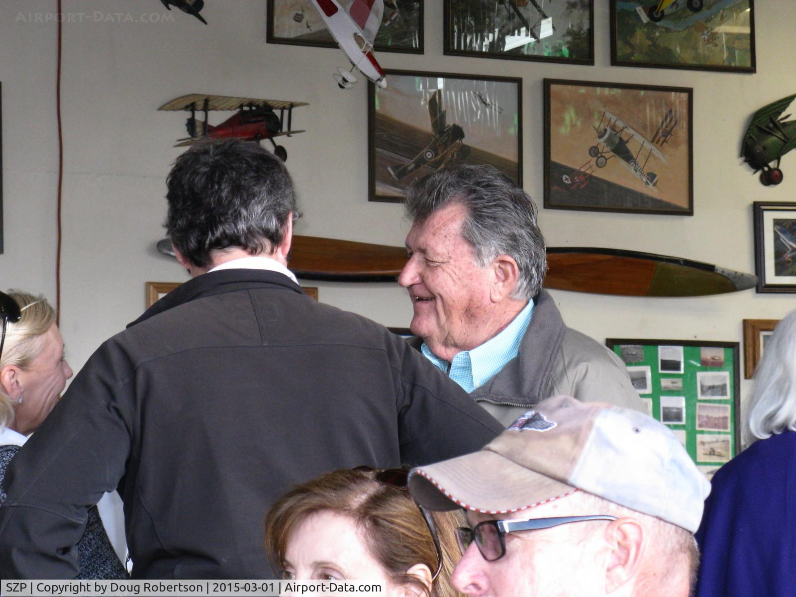 Santa Paula Airport (SZP) - Host Pat Quinn in his Bucker Museum Hangar greeting friends before the luncheon celebrating his 50 year flying FAA Wright Brothers Master Pilot Award. Pat has owned an incredible 55 airplanes in that time!!!