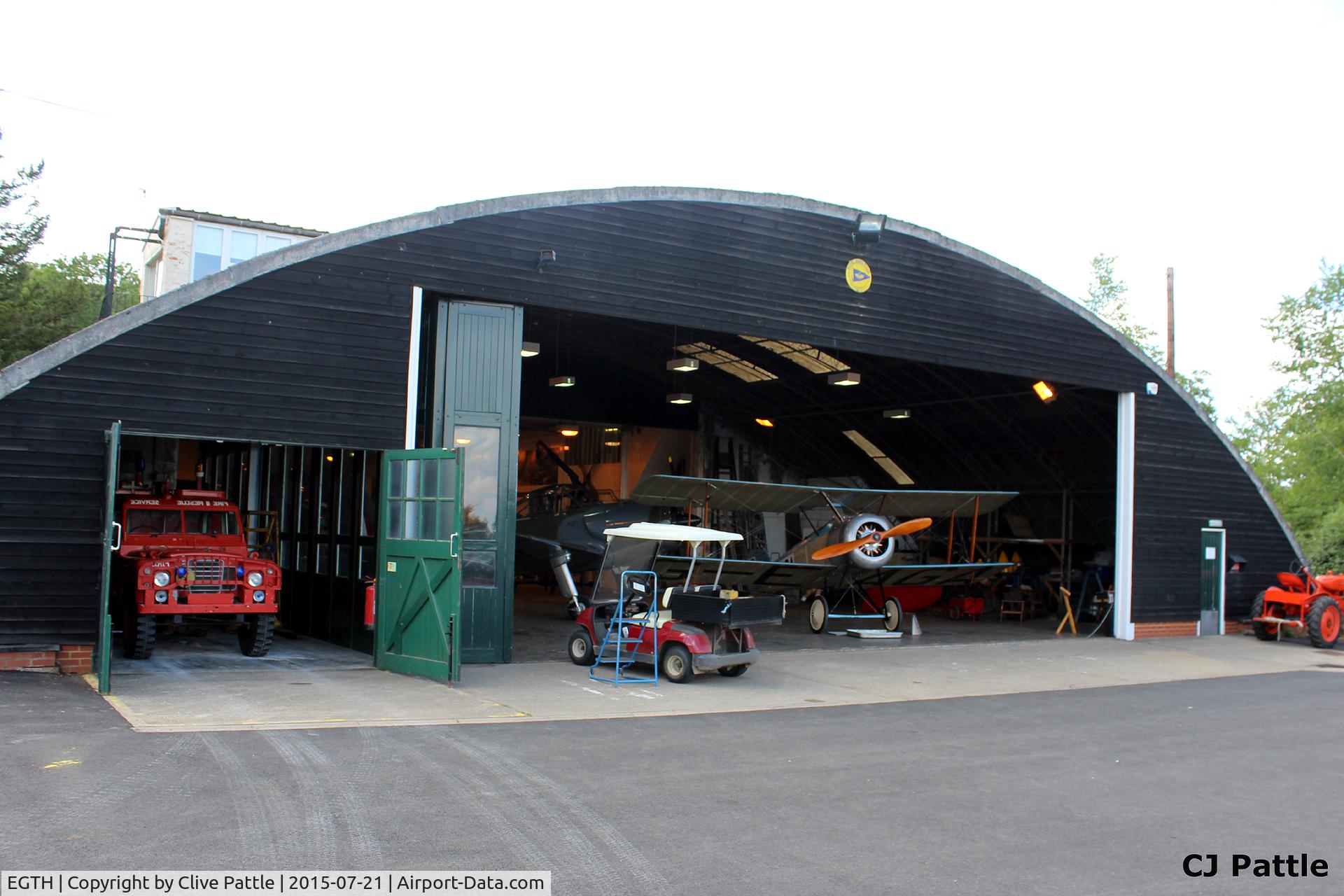 EGTH Airport - A view of one of the many hangars at The Shuttleworth Trust, Old Warden Airfield, offering a tantalising glimpse of some of the aviation occupants inside.
