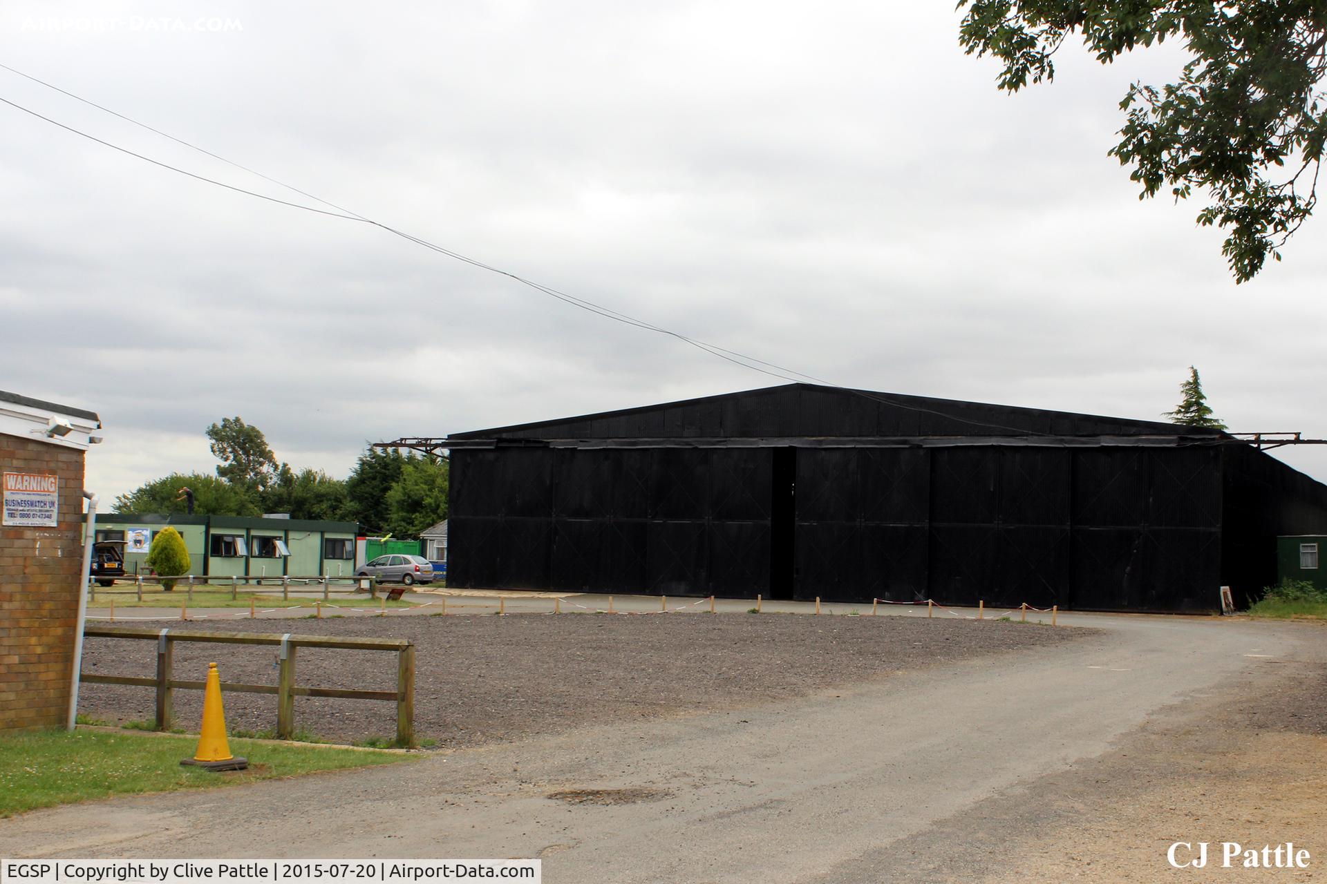 Peterborough/Sibson Airport, Peterborough, England United Kingdom (EGSP) - A view of one of the surviving WWII hangars, still occupied by aircraft, with the parachuting Cafe and Clubroom to the left at Sibson EGSP