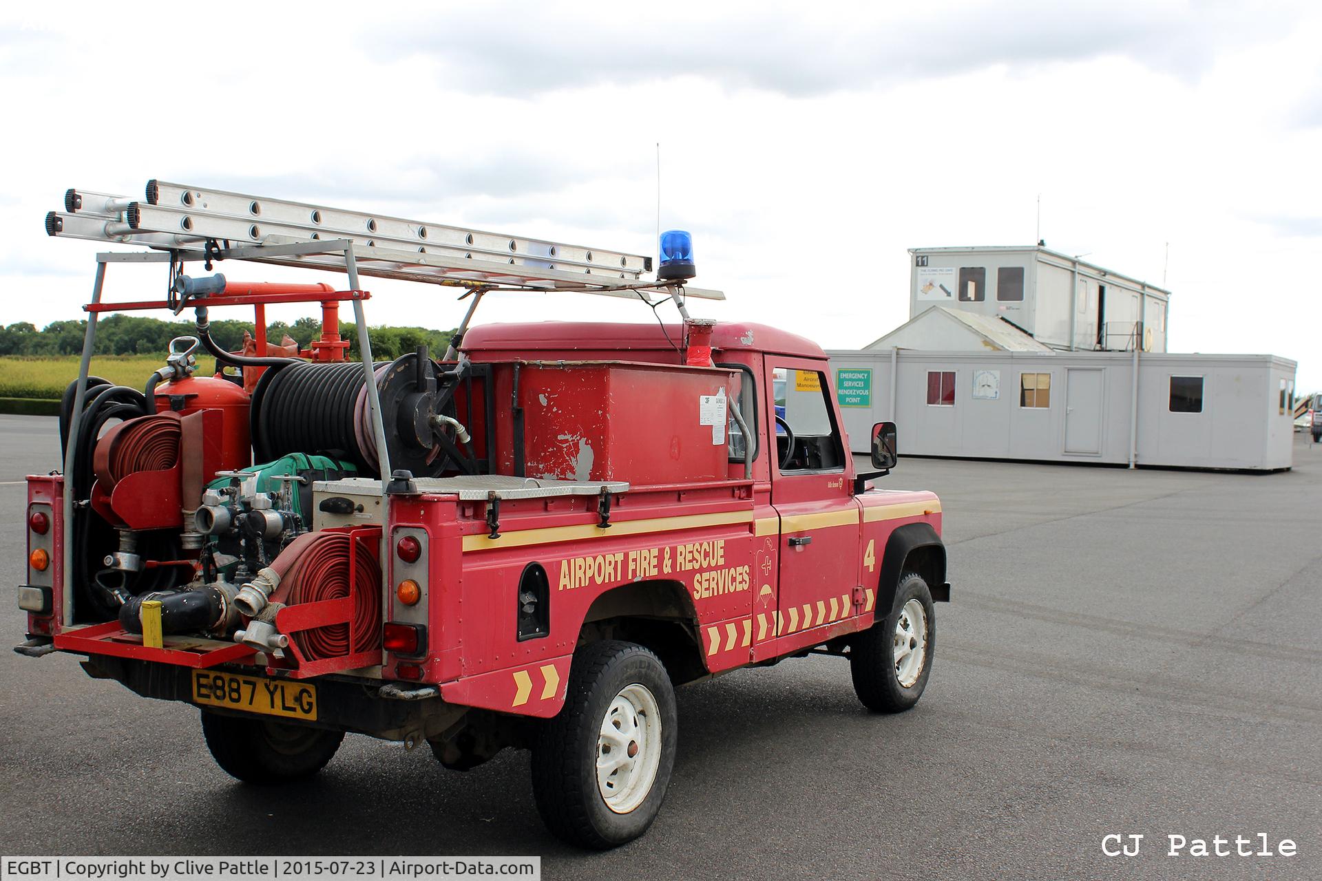 Turweston Aerodrome Airport, Turweston, England United Kingdom (EGBT) - The Fire Rescue Landrover at Turweston airfield with the temporary 'portacabin' ATC and Cafe accommodation in the background.