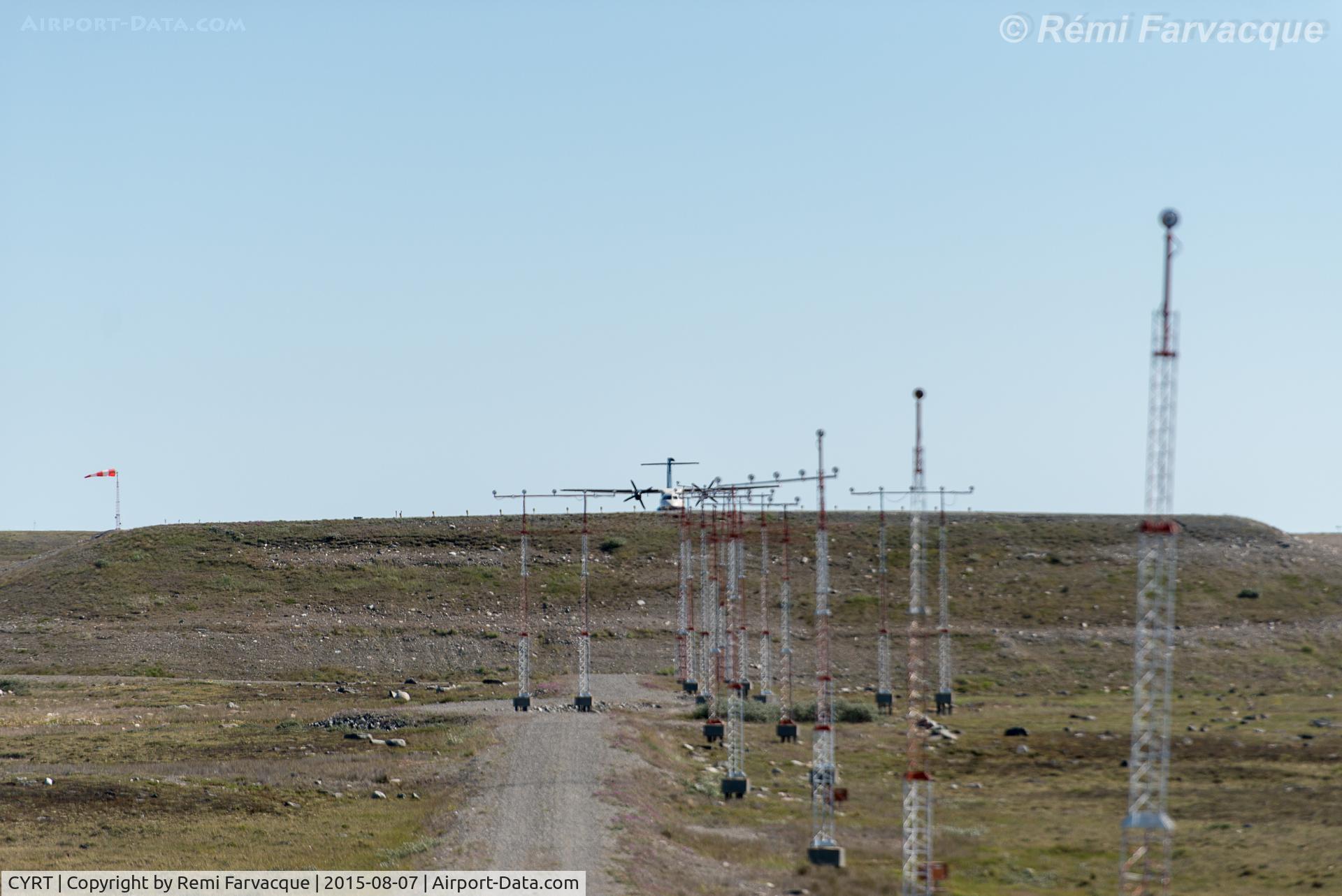 Rankin Inlet Airport, Rankin Inlet, Nunavut Canada (CYRT) - View to southeast of west end of runway with aircraft taxiing in to turn around, @ 1346h. 