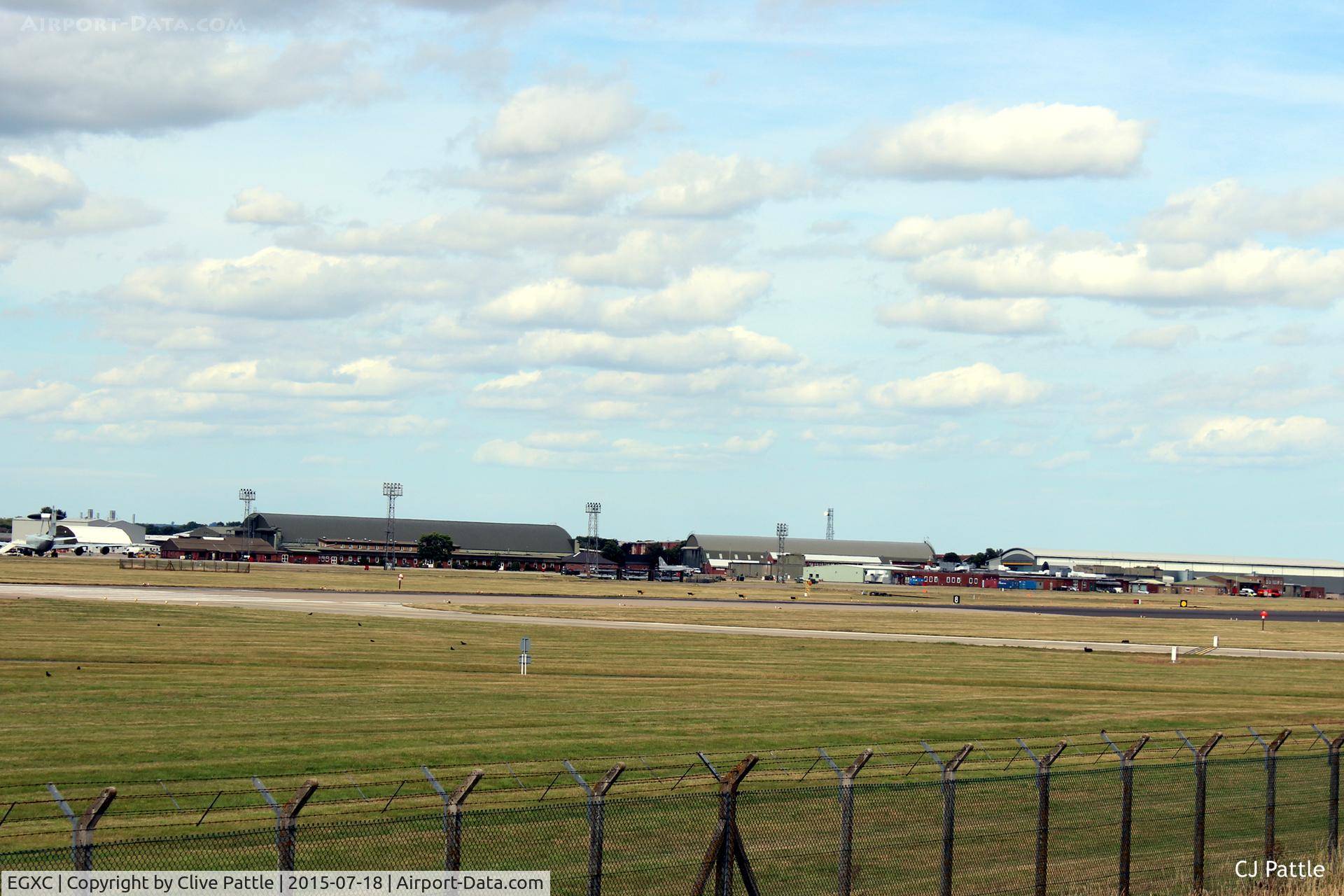 RAF Coningsby Airport, Coningsby, England United Kingdom (EGXC) - Airfield view RAF Coningsby EGXC - viewed from the south side, the 29 (R) Sqn hangar and buildings. The 'Gate Guard' English Electric Lightning can be seen mid image. 