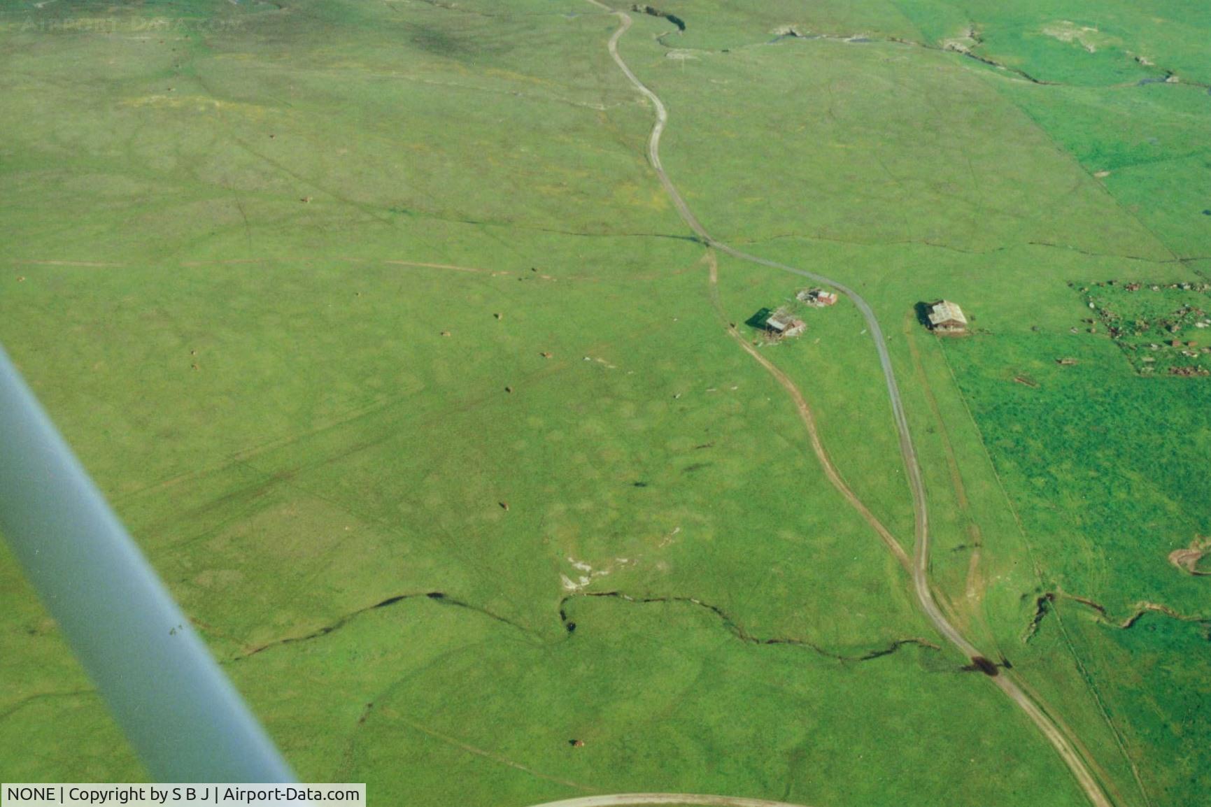 NONE Airport - Orvis ranch in central calif which was active in the 50s & 6os. The left hangar housed a Twin Bonanza C50 with a Cub in the far hangar. In the early 70s I flew over the C50 a mile east. It was only the fuselage.Never found out the story behind it. 