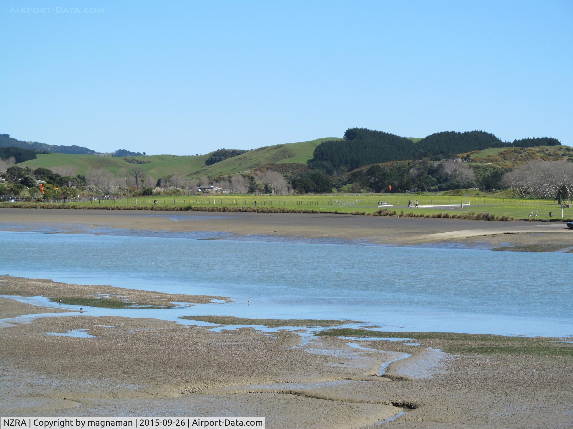 Raglan Aerodrome Airport, Raglan New Zealand (NZRA) - View from across river. A grass strip. No based aircraft but gets regular visitors in summer. Annual fly in very popular. Public footpath crosses runway and easy for photos and parking available next to fence.