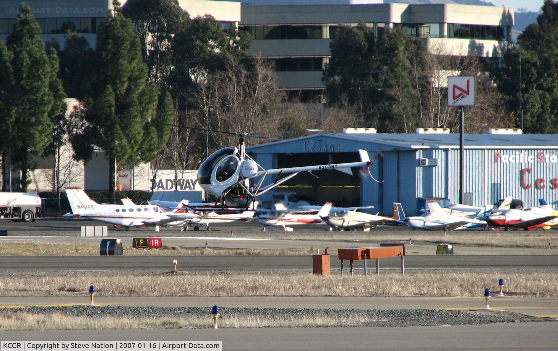 Buchanan Field Airport (CCR) - Pacific States Aviation offices, hangar and showroom @ Buchanan Field, Concord, CA on a windy January day (Hughes 369 hovering in foreground was with Bristow Academy)