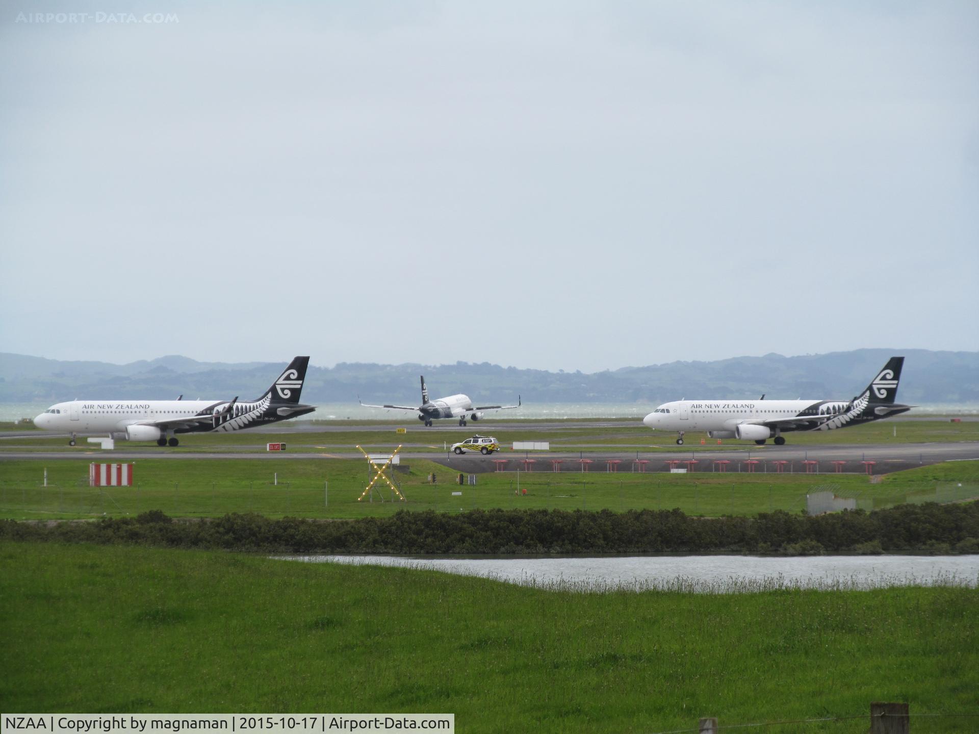 Auckland International Airport, Auckland New Zealand (NZAA) - ZK-OXJ and OXF queuing to leave with OXI just landing in between. View from public lay-by off Puhinui Road.