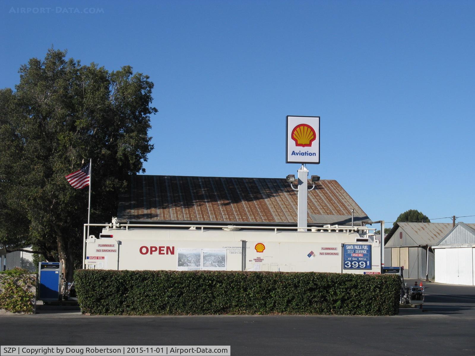 Santa Paula Airport (SZP) - Santa Paula Airport Self-Serve SHELL 100LL fuel dock. Location: Mid-Field North, fuel price unchanged, still lowest in Ventura County? Note flag showing east wind, wind tee and both windsocks confirmatory, yet were 5 downwind landings early on.