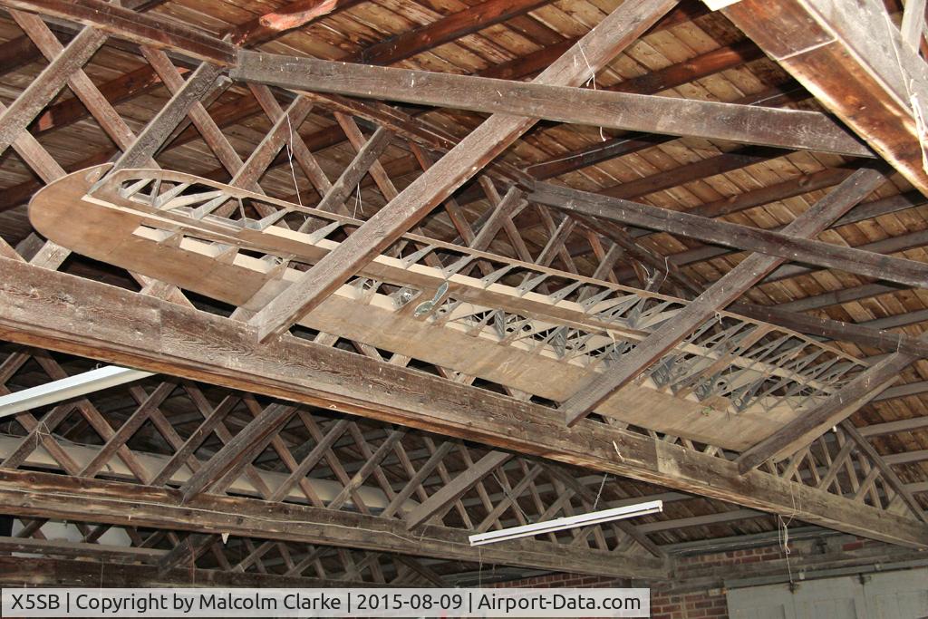 X5SB Airport - A skeletal glider wing in the roof of a hangar at The Yorkshire Gliding Club, Sutton Bank. August 9th 2015.