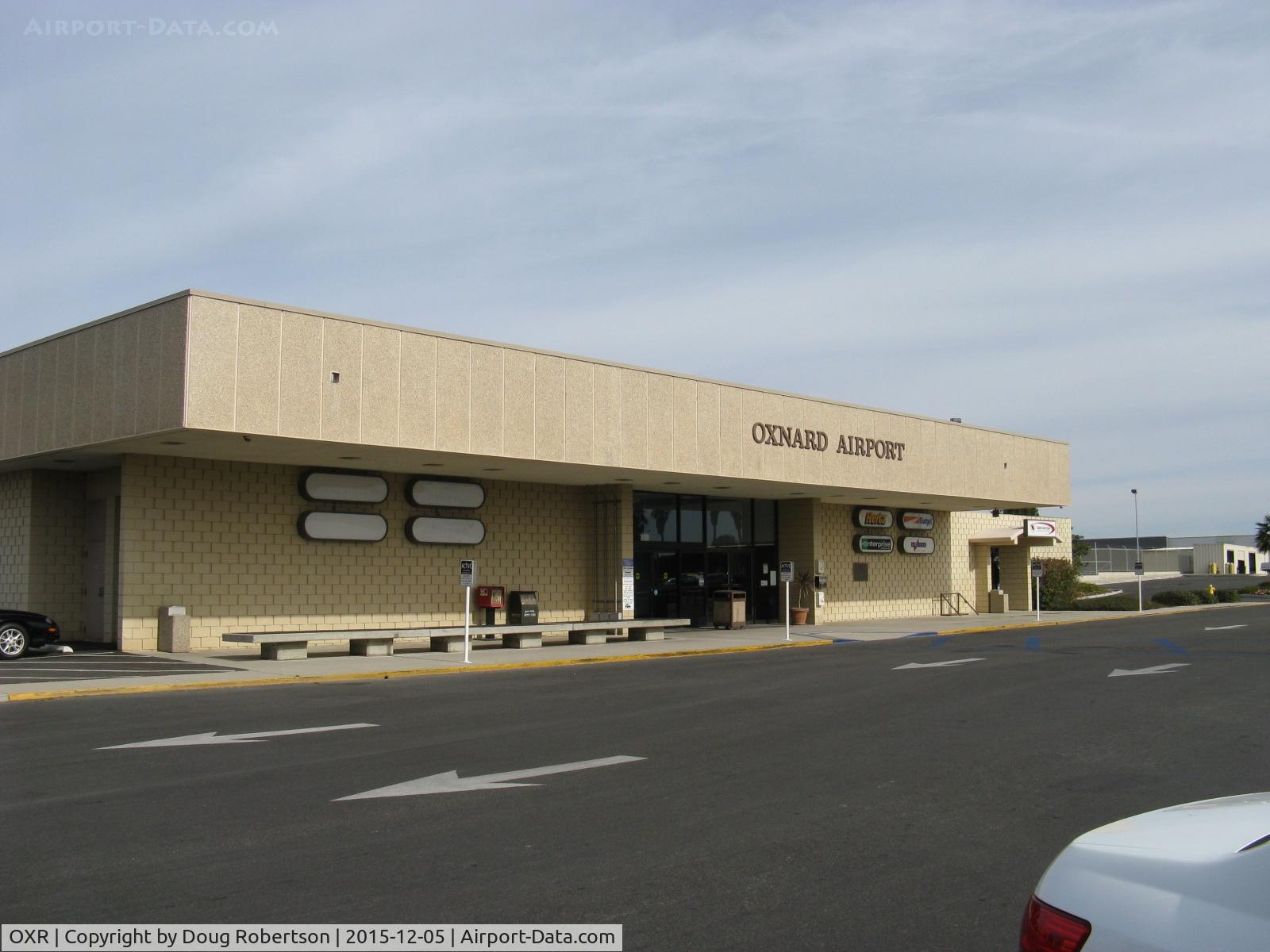 Oxnard Airport (OXR) - Oxnard Airport Terminal Building. No commercial commuter passenger flights have been offered to/from OXR since Summer 2010. The terminal only provides various rental vehicle services. Note the four blank placards.