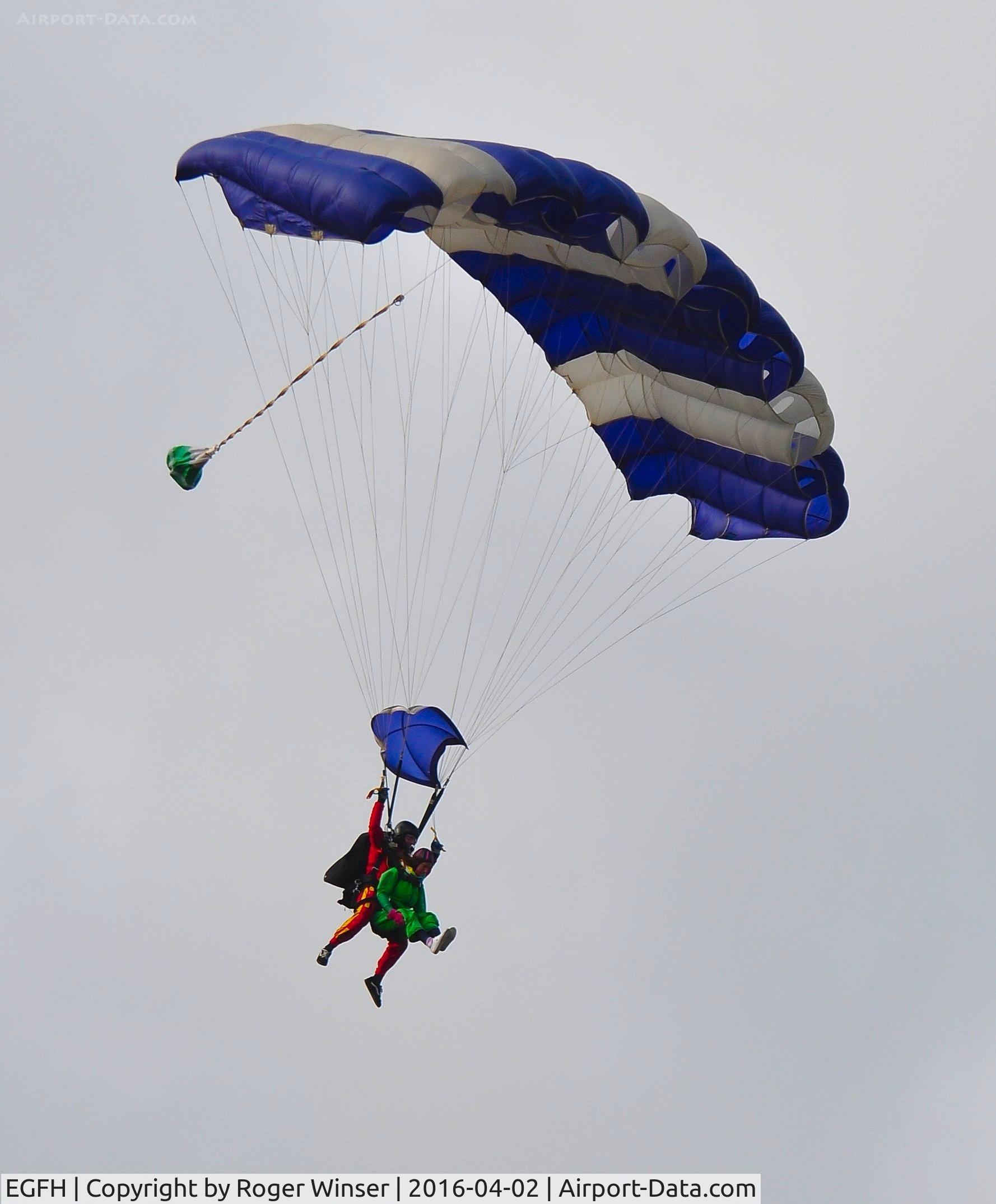 Swansea Airport, Swansea, Wales United Kingdom (EGFH) - Tandem skydivers from Skydive Swansea dropping in from 12000 feet.
