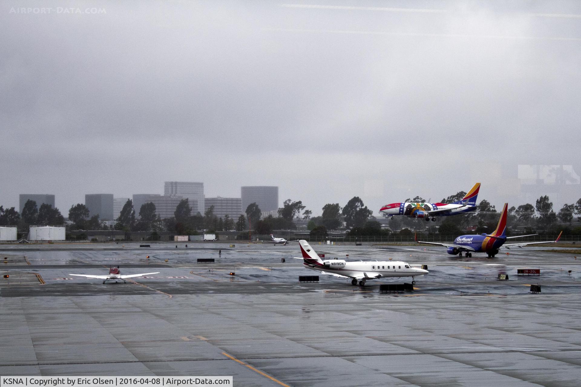 John Wayne Airport-orange County Airport (SNA) - Four a/c waiting to take off and a Southwest flight landing.