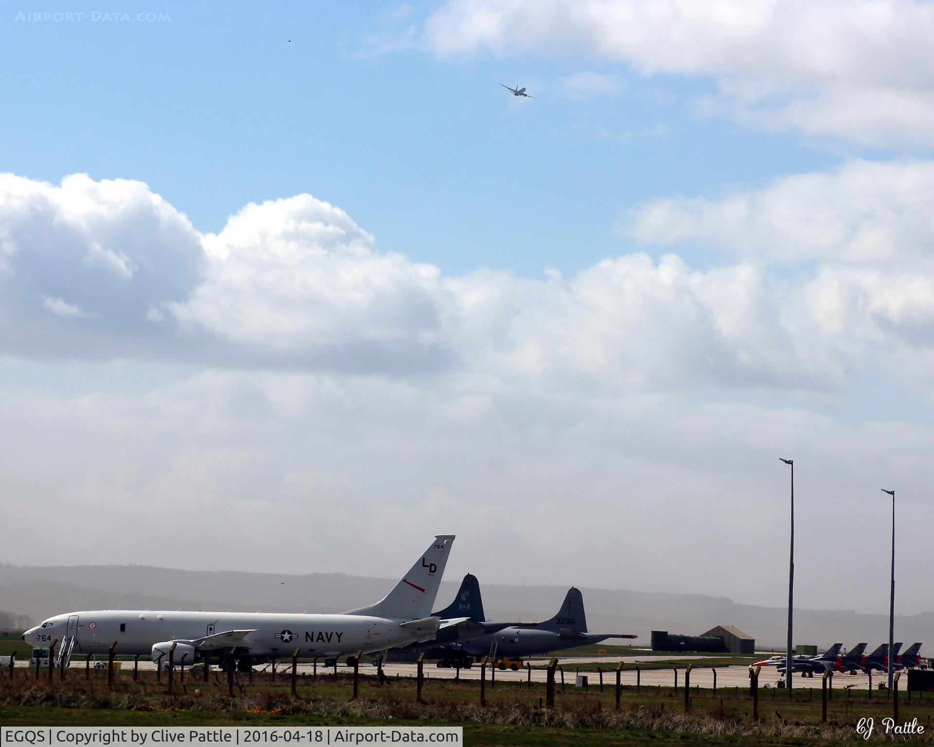 RAF Lossiemouth Airport, Lossiemouth, Scotland United Kingdom (EGQS) - Airport scene at RAF Lossiemouth EGQS  - during Exercise Joint Warrior 16-1. P-8A 168764 and other participants parked up whilst 168763 takes off in the distance.