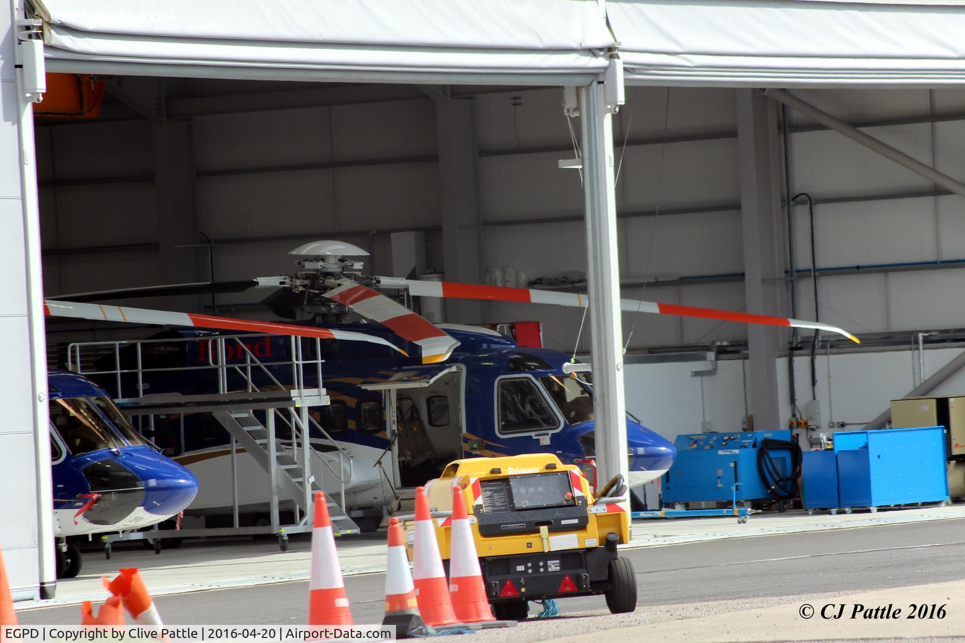 Aberdeen Airport, Aberdeen, Scotland United Kingdom (EGPD) - A sneaky peek inside one of the Bond Offshore maintenance hangars at Aberdeen EGPD