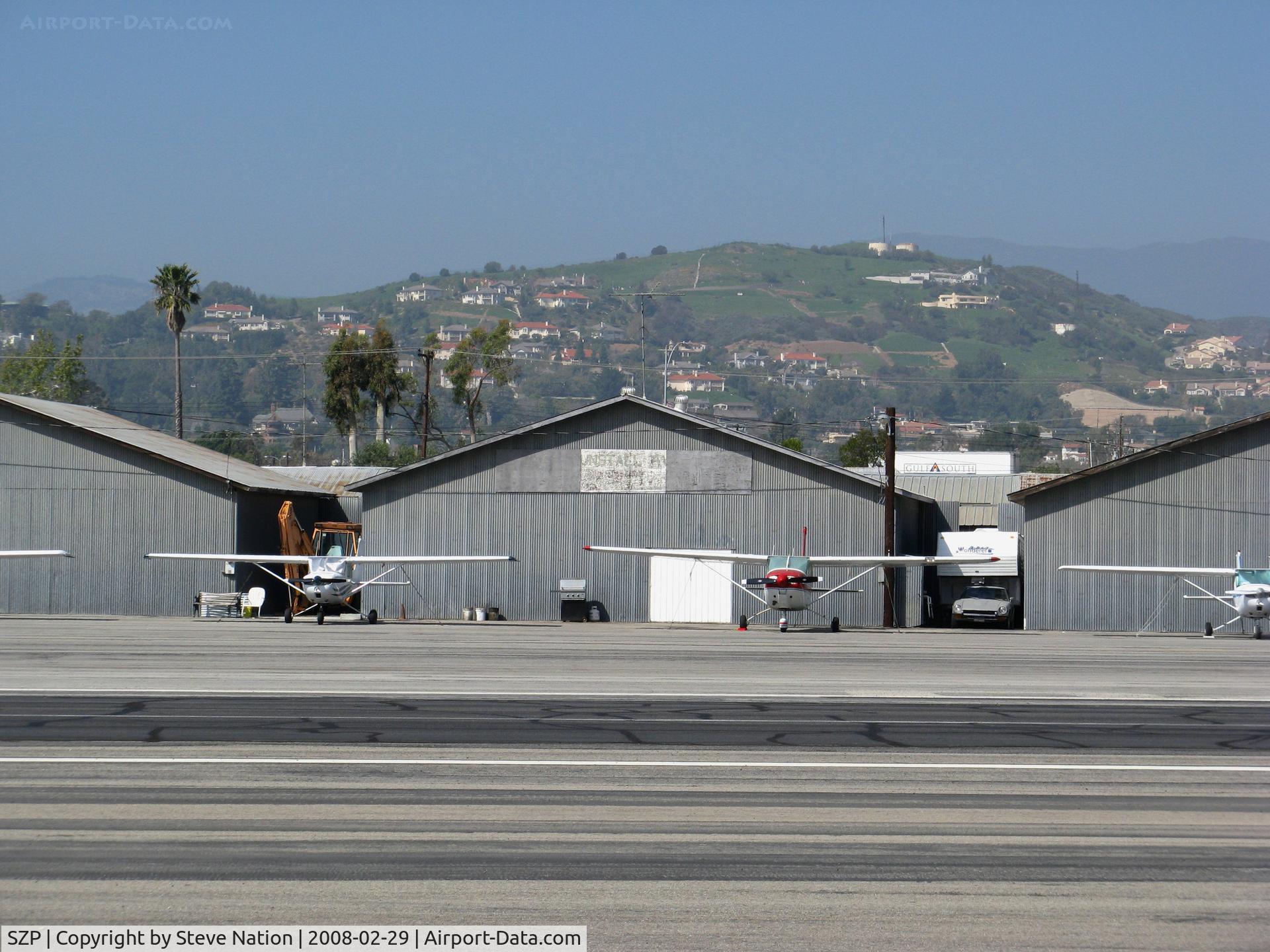 Santa Paula Airport (SZP) - Tin hangars on north side of Santa Paula Airport (Ventura County), CA with hilltop in background