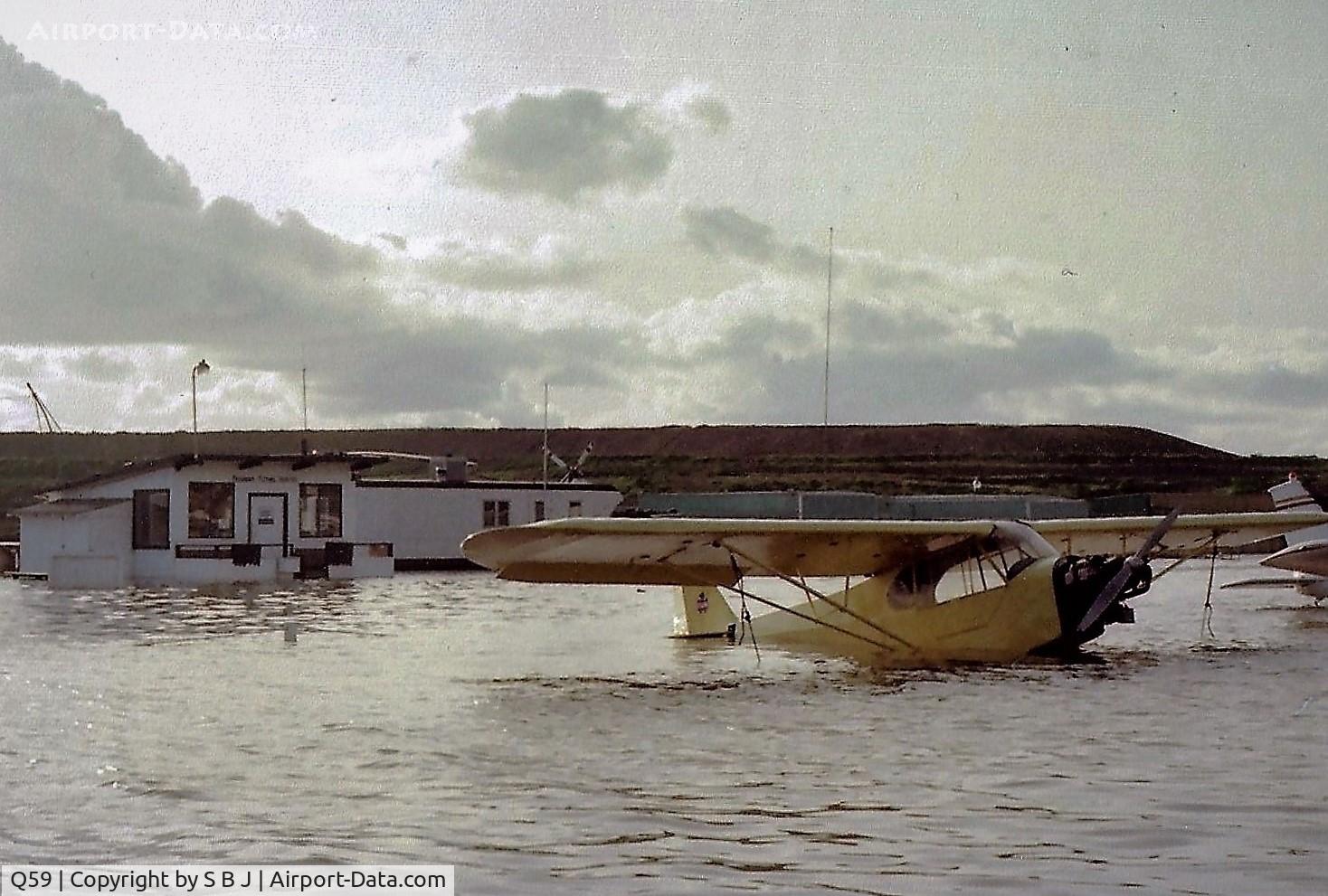 Q59 Airport - From time to time, Fremont airport would go from a land base to a seaplane based airport. Unfortunately for Cub 30472, this was one of those times. The Fremont flight school is seen behind 472. They did not offer any floatplane instruction.