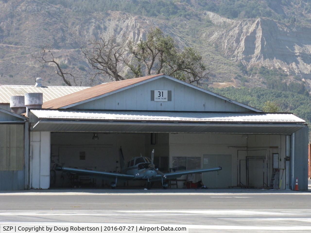 Santa Paula Airport (SZP) - Santa Paula Airport Do-It-Yourself Aircraft Paint Facility. Rare to see doors open, some masking of a Piper PA-28 is being done, and it is already hot mid-morning.