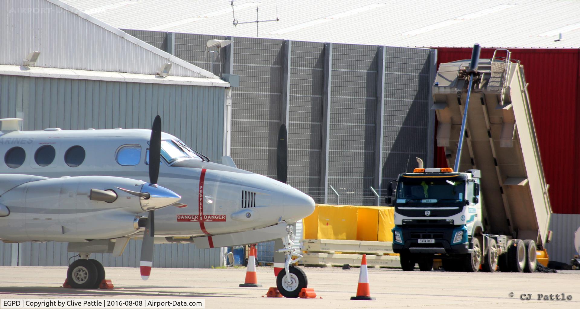 Aberdeen Airport, Aberdeen, Scotland United Kingdom (EGPD) - Re-surfacing work underway at the Babcock MCS Offshore (formerly Bond Helicopters) apron at Aberdeen. Parked up is a visiting USMC UC-12W.