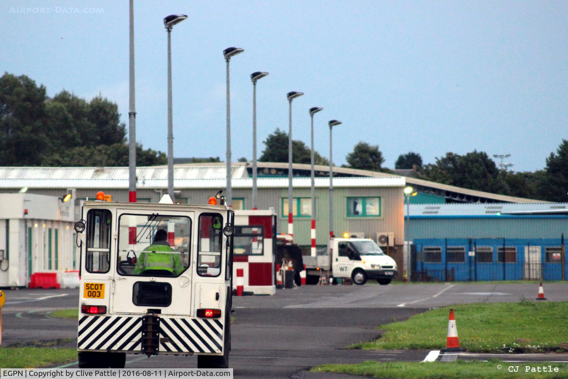 Dundee Airport, Dundee, Scotland United Kingdom (EGPN) - Towing tug chugs off at 'high speed' to put Dornier 328-100 G-BYHG to bed for the night at Dundee EGPN