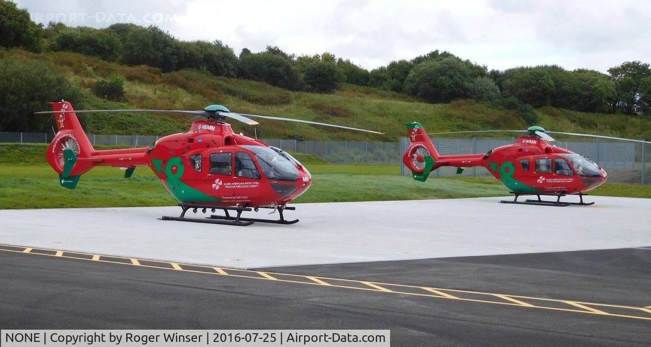 NONE Airport - The two Wales Air Ambulance helicopters (G-HEMN and G-WASN) at their new base at Dafen, Llanelli, Wales UK.