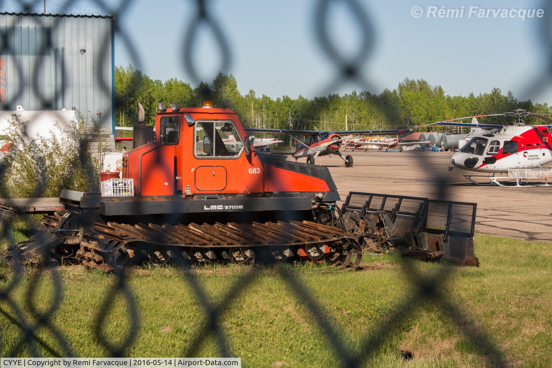 Fort Nelson Airport, Fort Nelson, British Columbia Canada (CYYE) - View north of snow removal equipment in corporate/private hangar area.