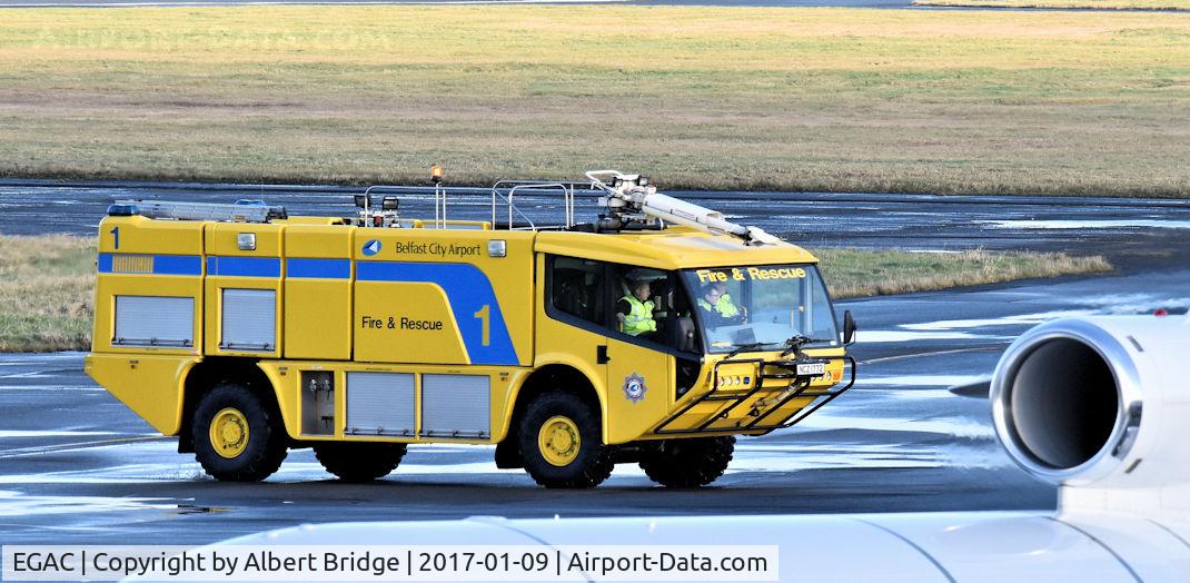George Best Belfast City Airport, Belfast, Northern Ireland United Kingdom (EGAC) - Carmichael Cobra no 1 in the City Airport Fire and Rescue fleet.  Air Alsie Dassault Falcon (OY-VIK) in the foreground.
